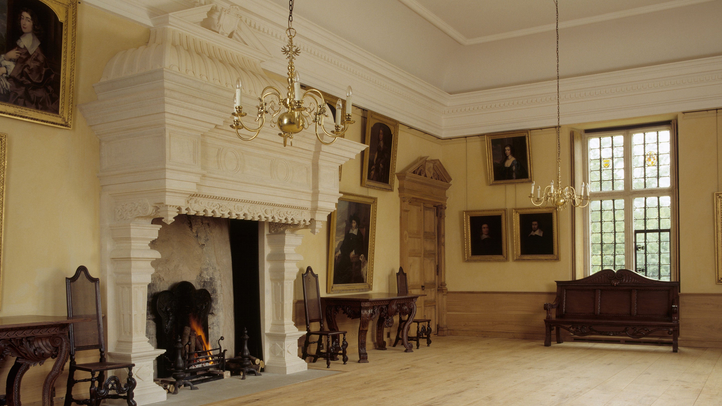 View of the Great Room showing fireplace, William Kent style bench, window & floor. Colossal, continental chimneypiece little known in England, made by Hereford Cathedral Workshop masons.