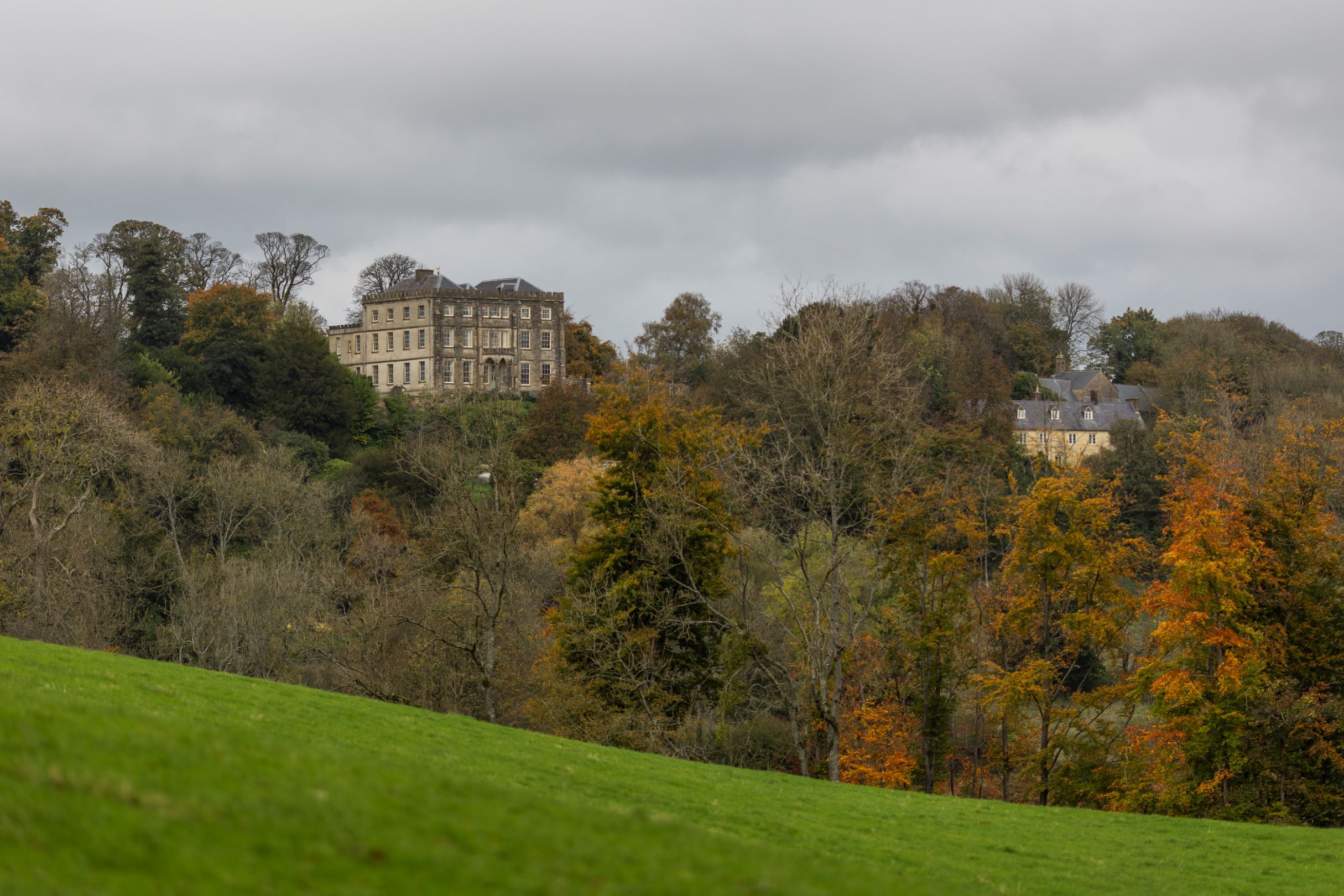 An autumn view of the house from estate walks, Newark Park, Gloucestershire