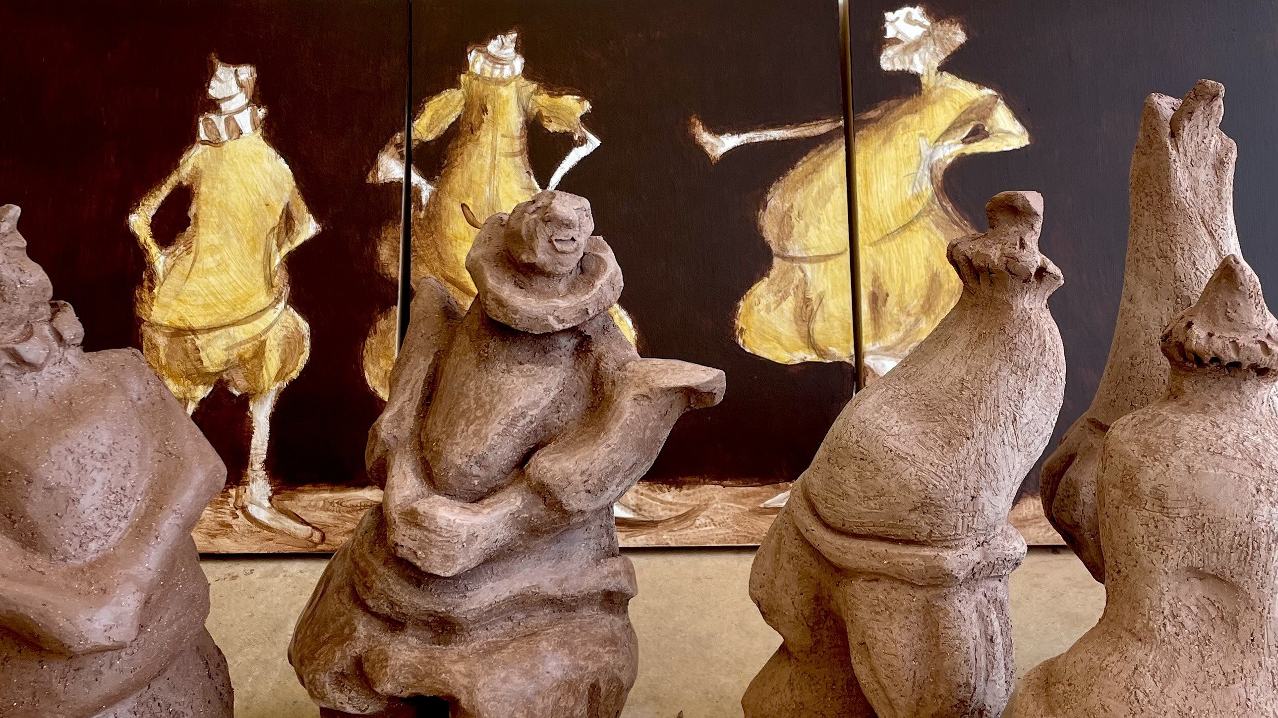 Clay forms with painting in background