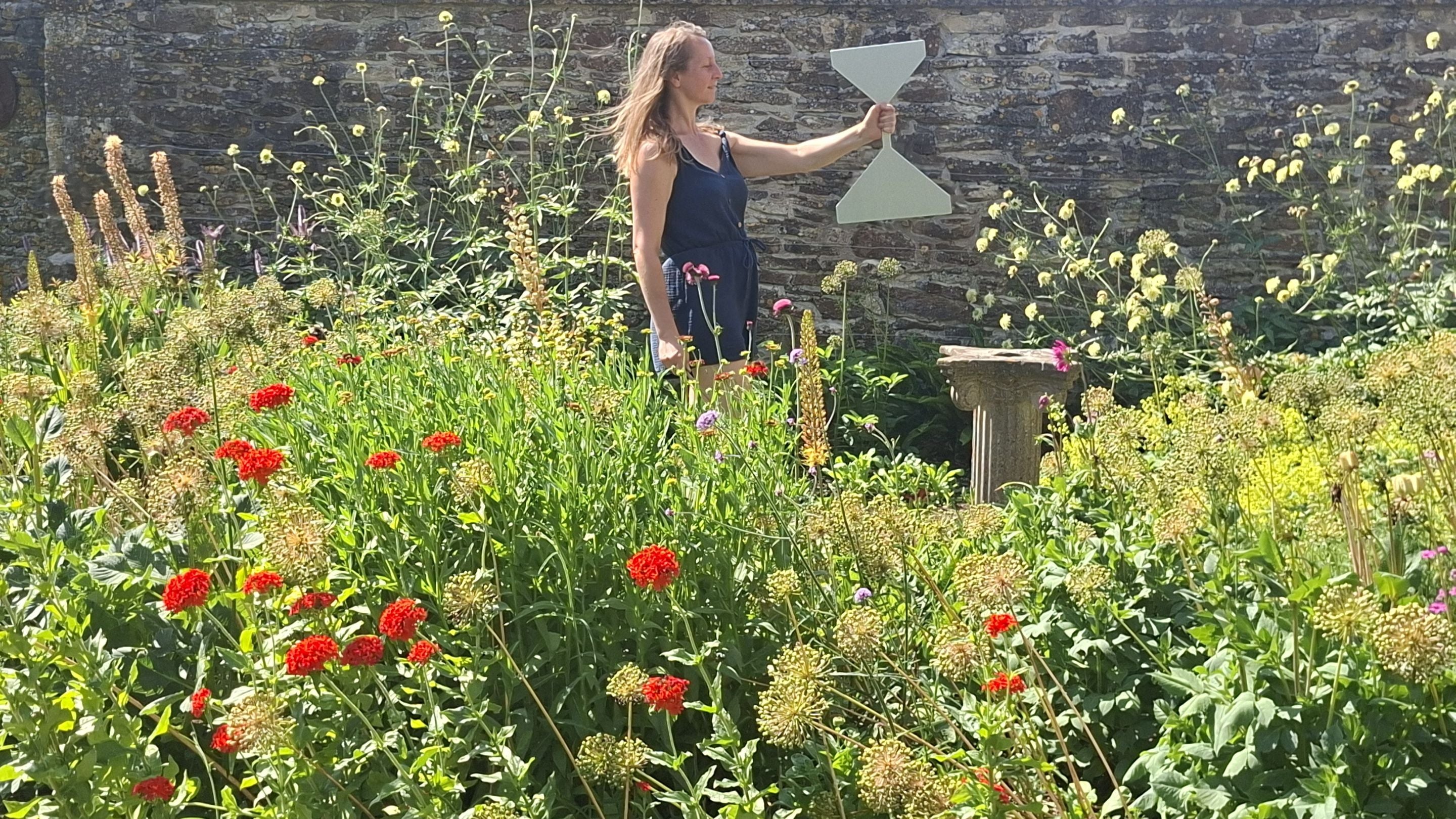 A woman standing in a flower garden