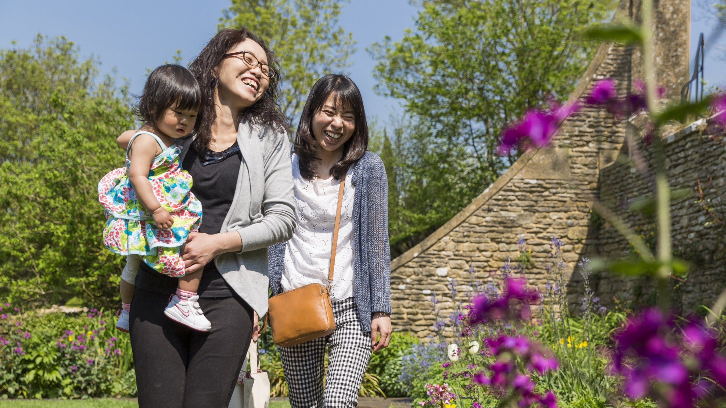 Visitors in the Armillary Court in at Snowshill Manor and Garden, Gloucestershire and Cotswolds