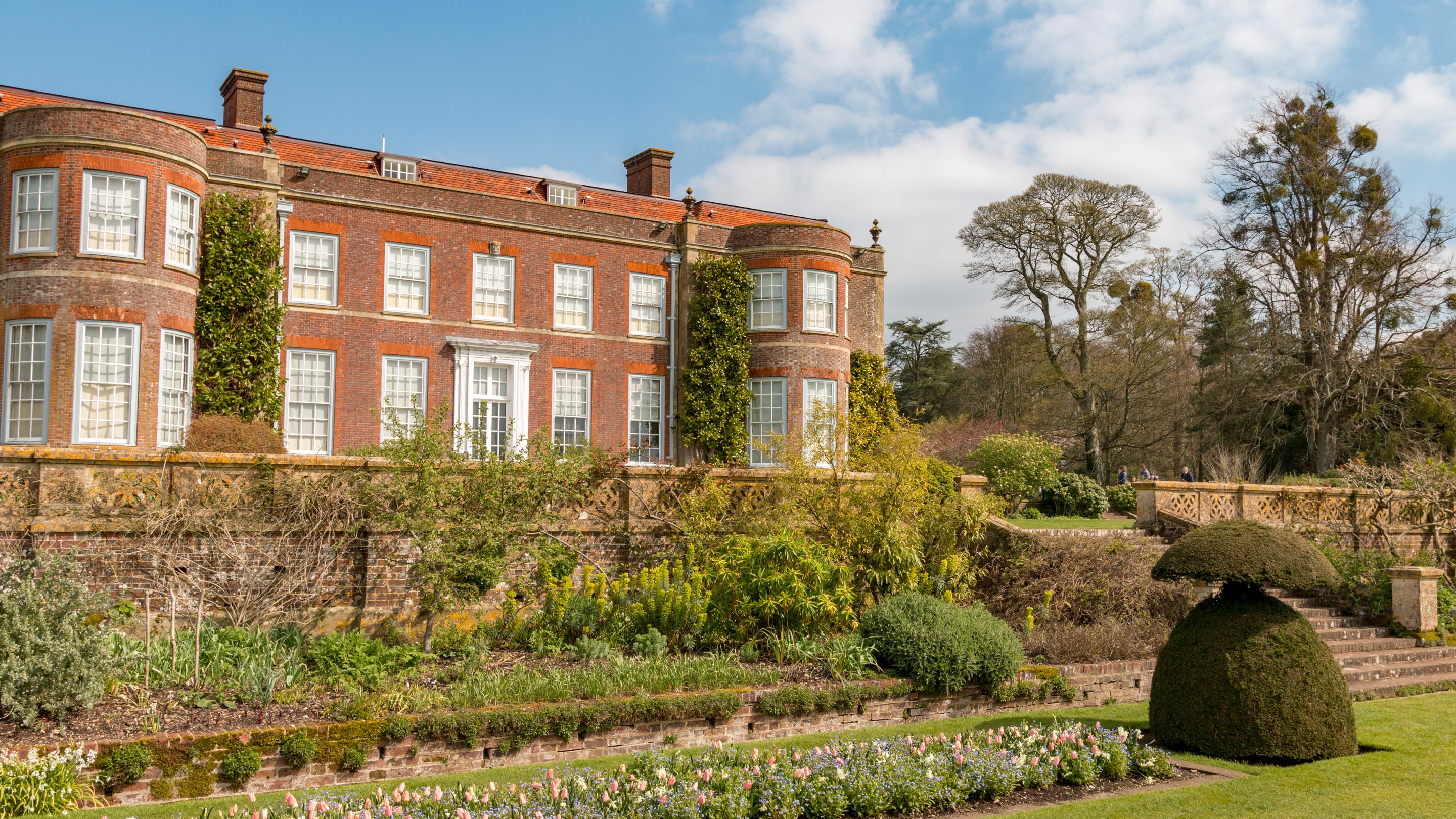 The garden with tulips in front of the house at Hinton Ampner