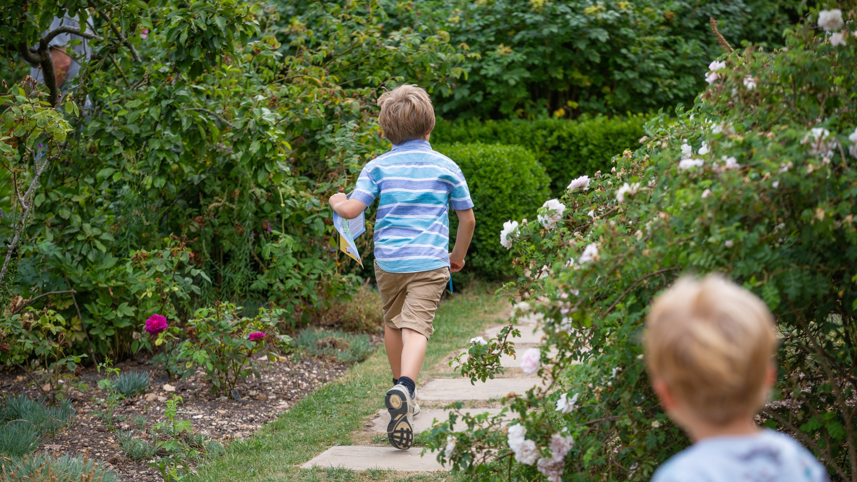 Children taking part in a trail in the rose garden at Mottisfont, Hampshire