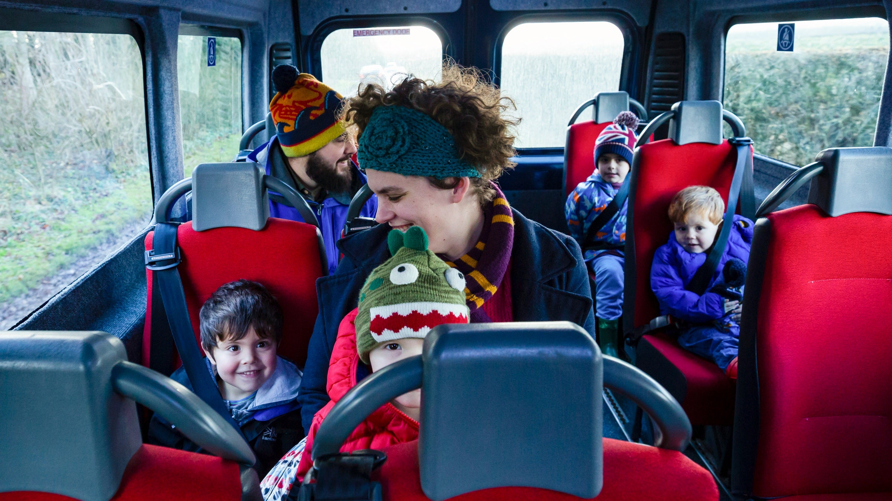 A family sit in a minibus