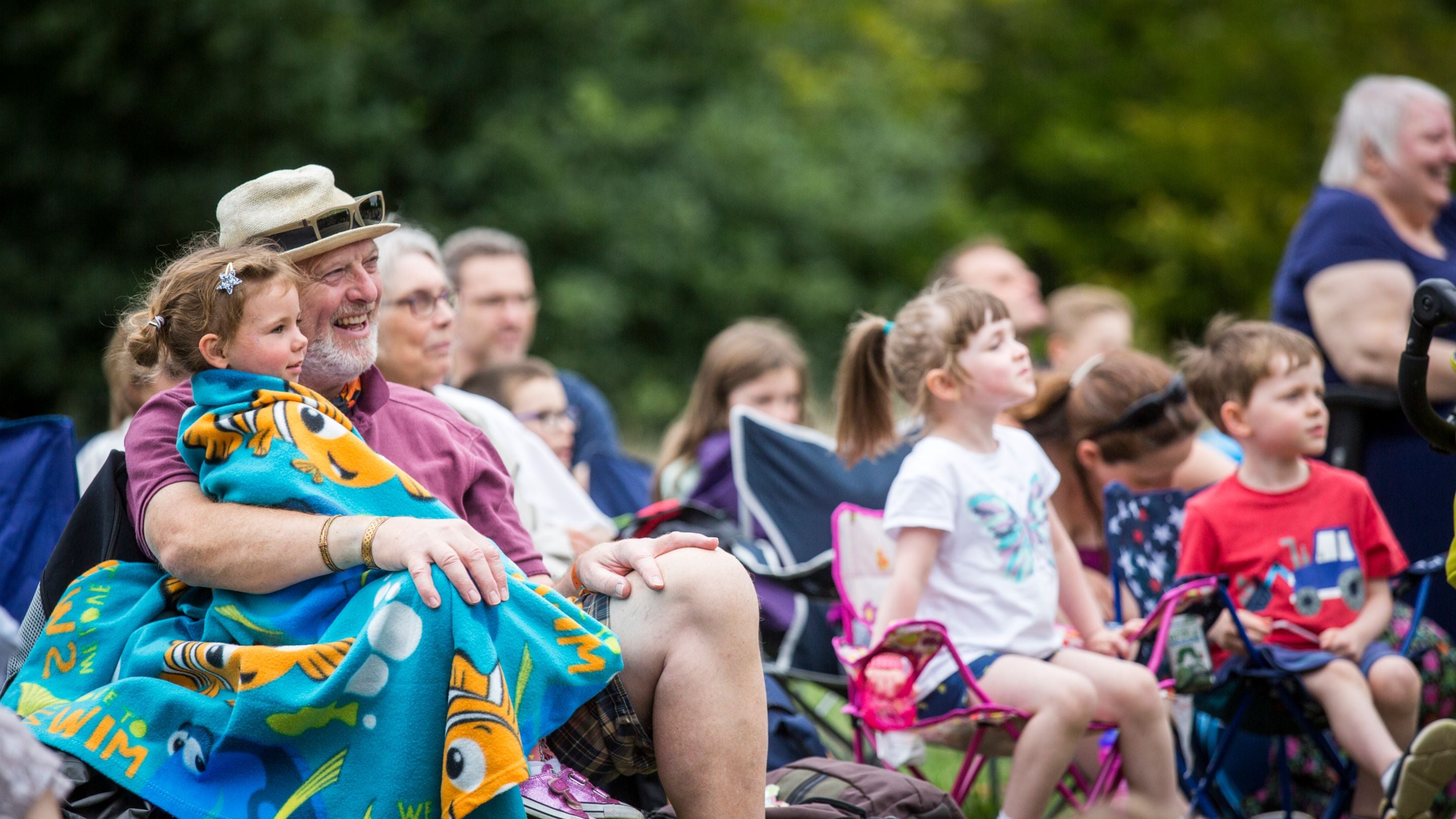 Families enjoy an outdoor show