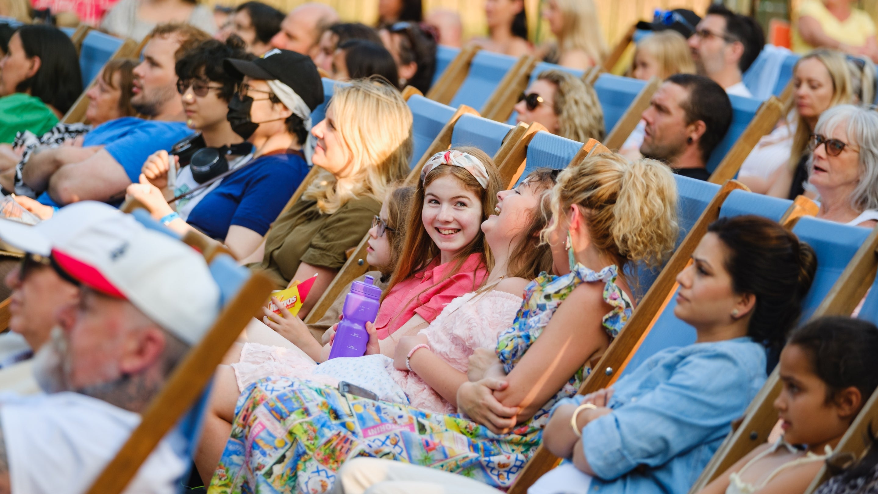 A crowd enjoy an open-air event.