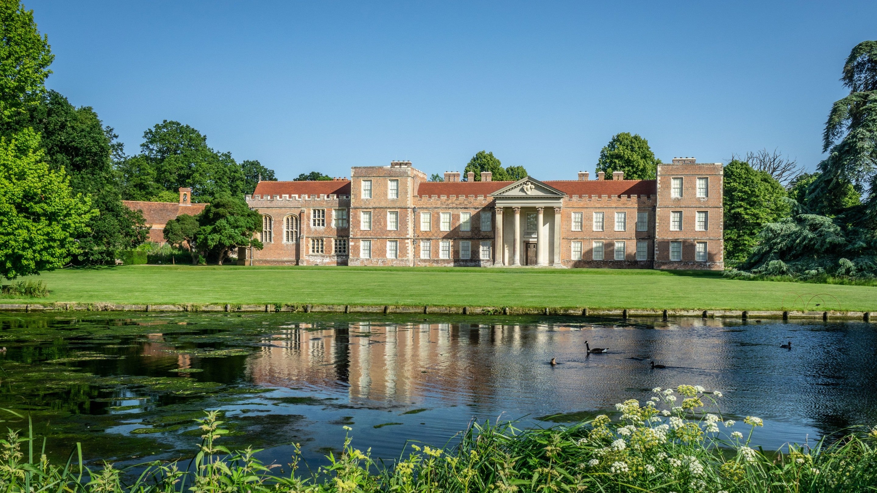 A view of the house at The Vyne from across the lake.