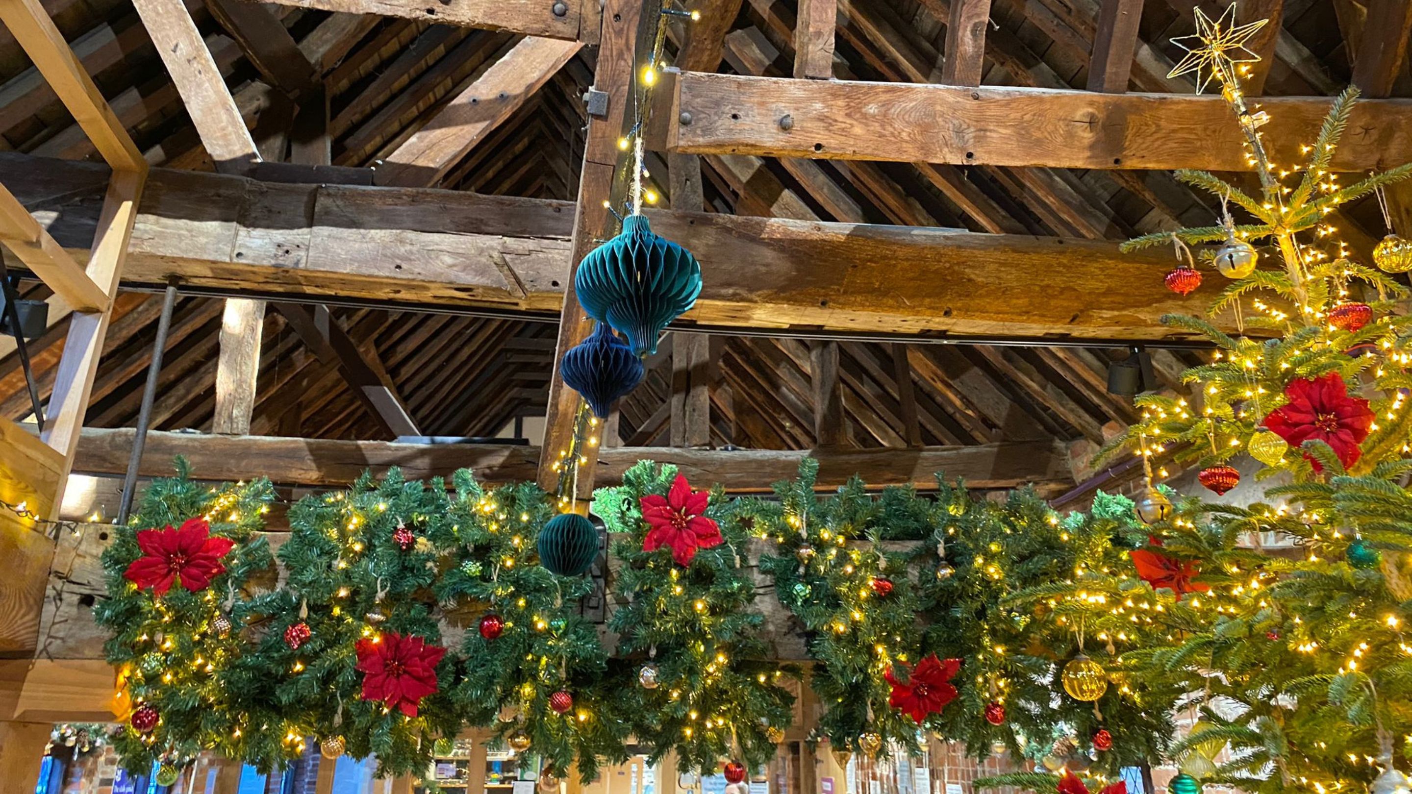 Christmas decorations tied onto the wooden beams in the roof space of Winchester City Mill