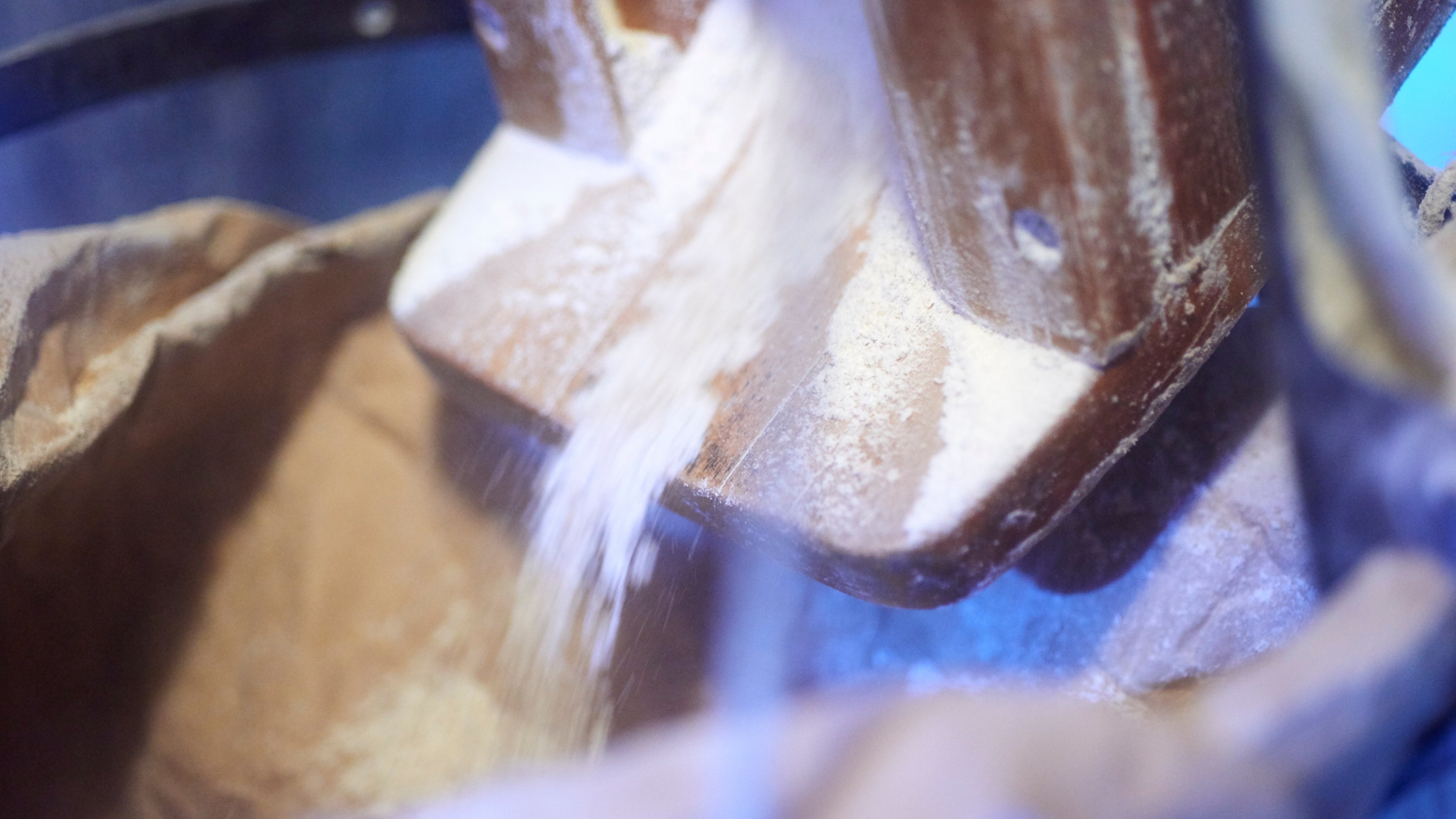 Freshly ground flour falling from a chute at Winchester City Mill, Hampshire