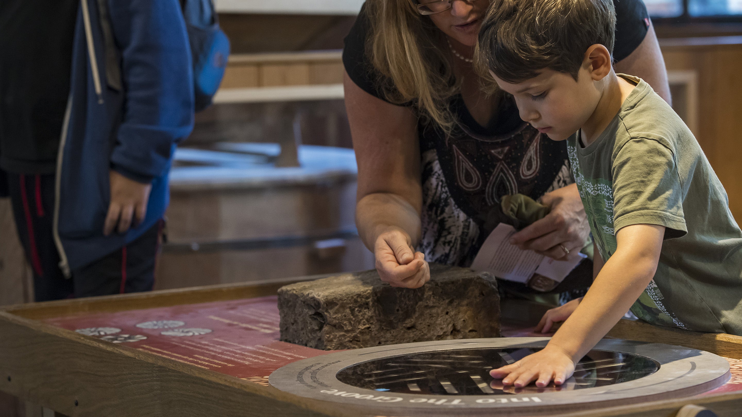 A child takes part in a milling demonstration at Winchester City Mill, Hampshire