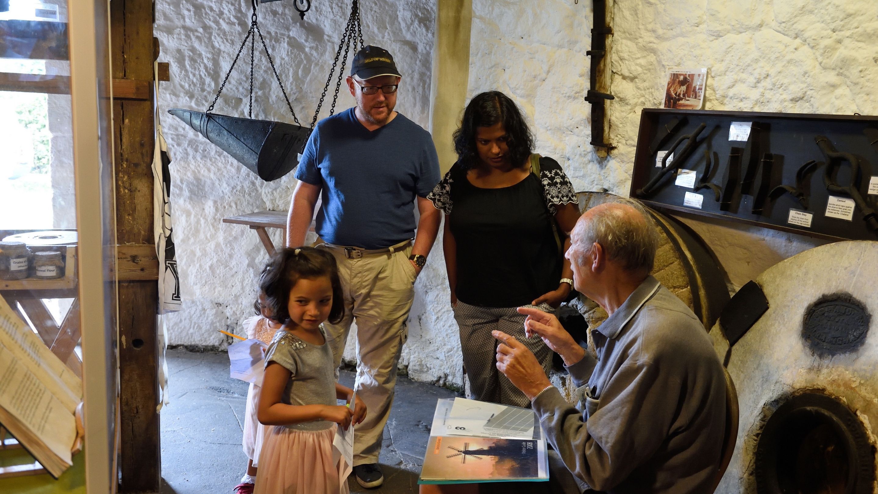 Volunteer guide speaking with visitors at Bembridge Windmill, Isle of Wight