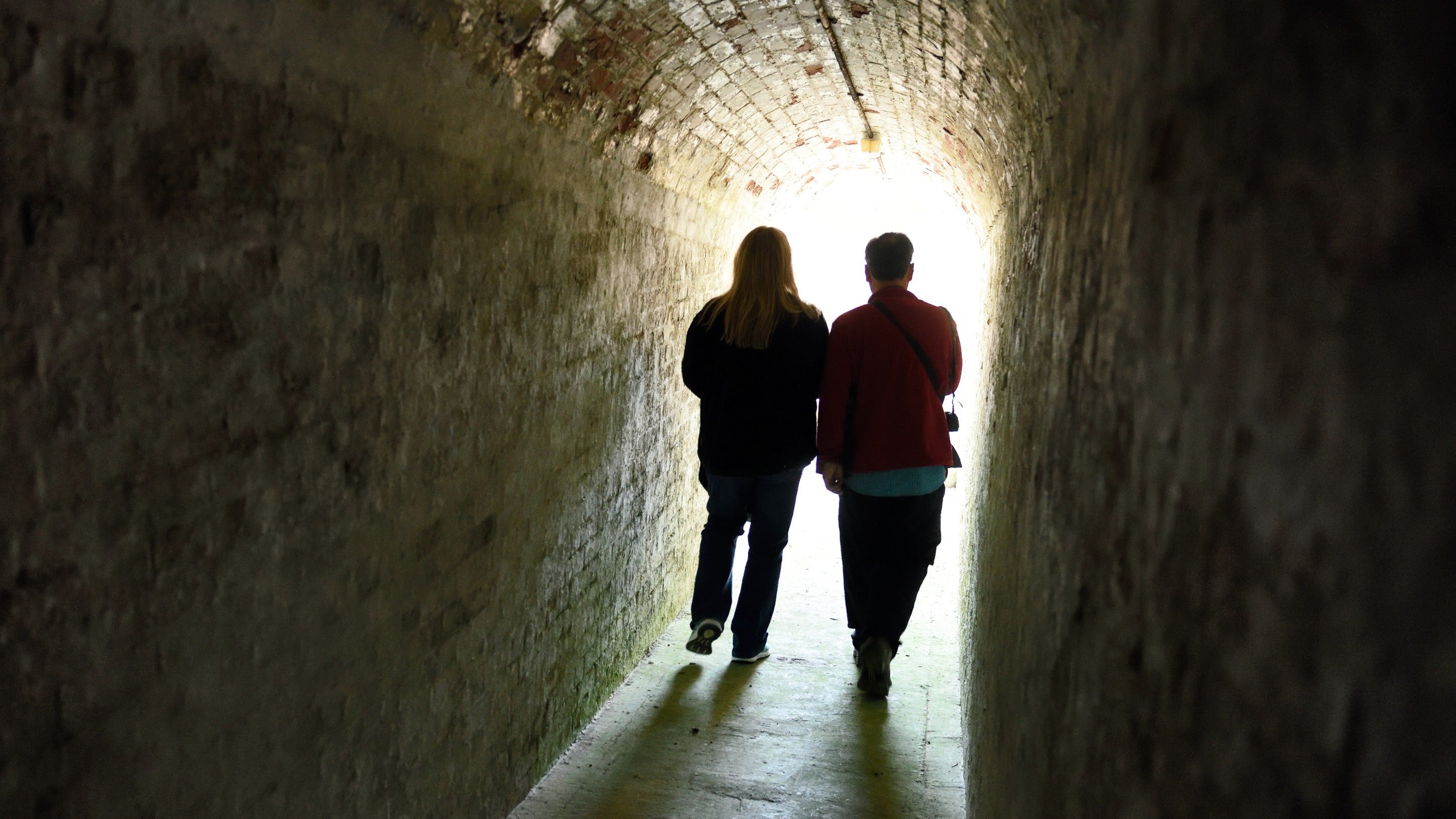 Visitors walking through a tunnel at Bembridge Fort, Isle of Wight
