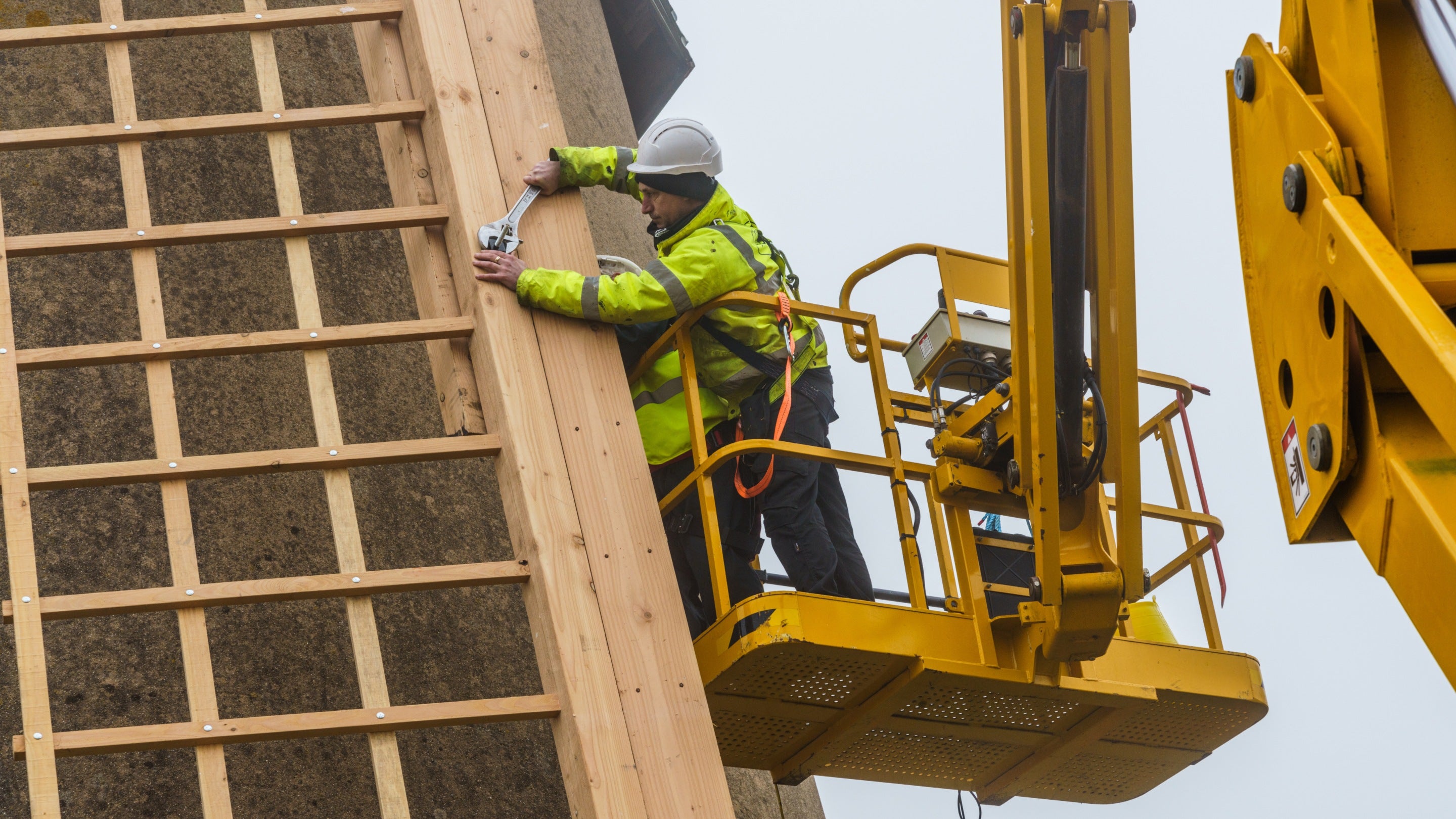 Workman with spanner installing the new sweeps on Bembridge Windmill, Isle of Wight