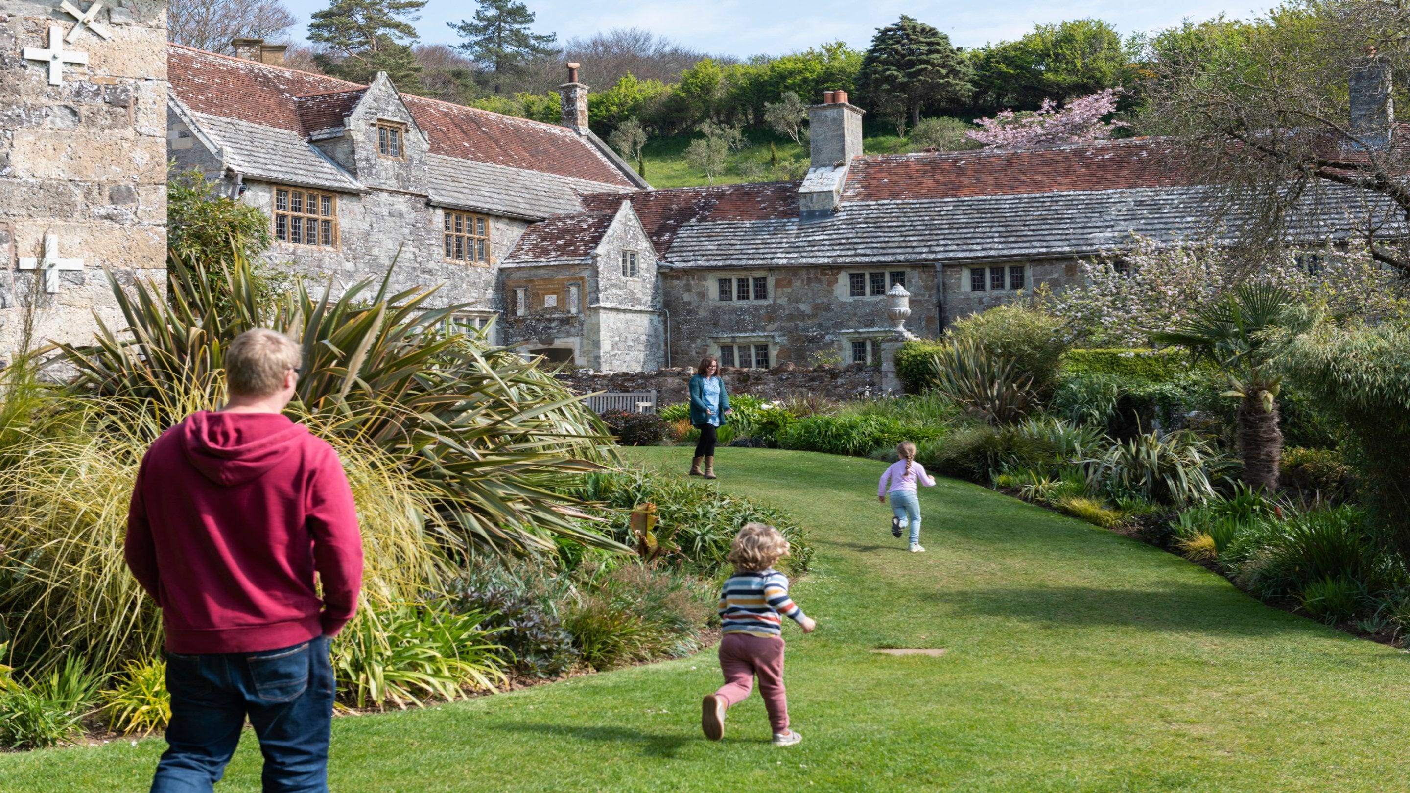 Family walking through the gardens at Mottistone Manor and Gardens