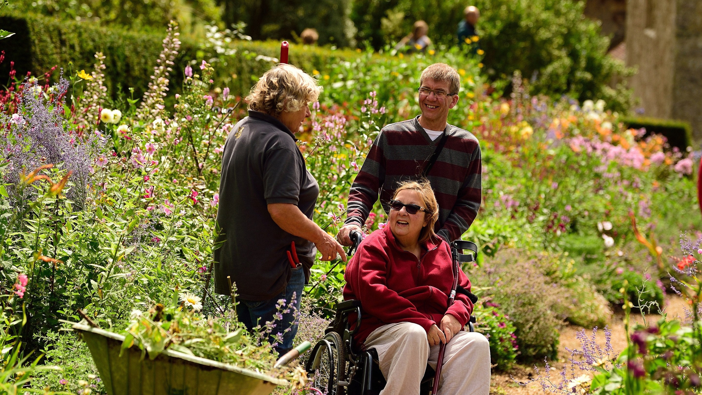 Garden volunteer speaking with visitors at Mottistone Gardens, Isle of Wight