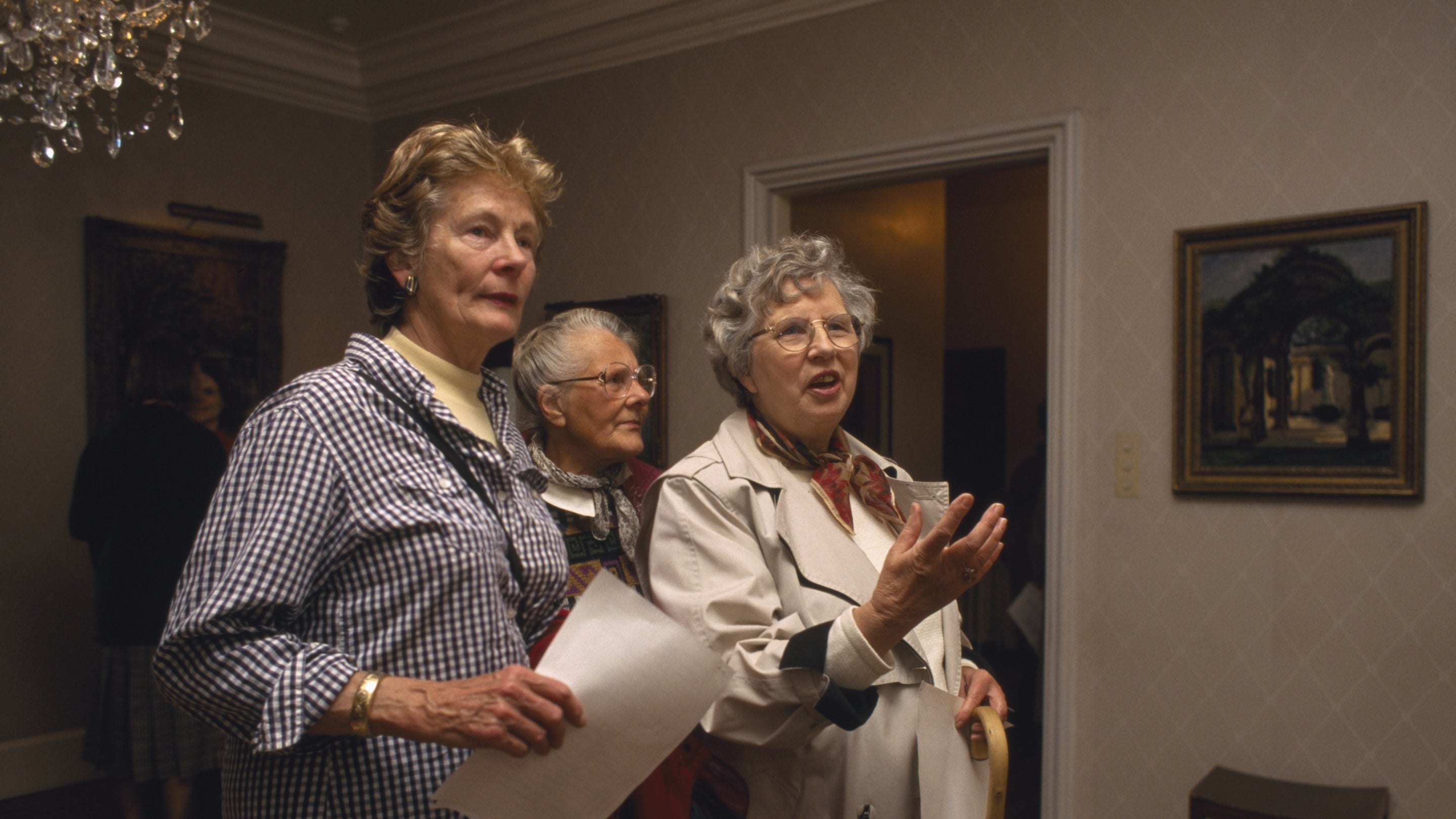 A group of adults admiring the paintings inside the house at Chartwell, Kent