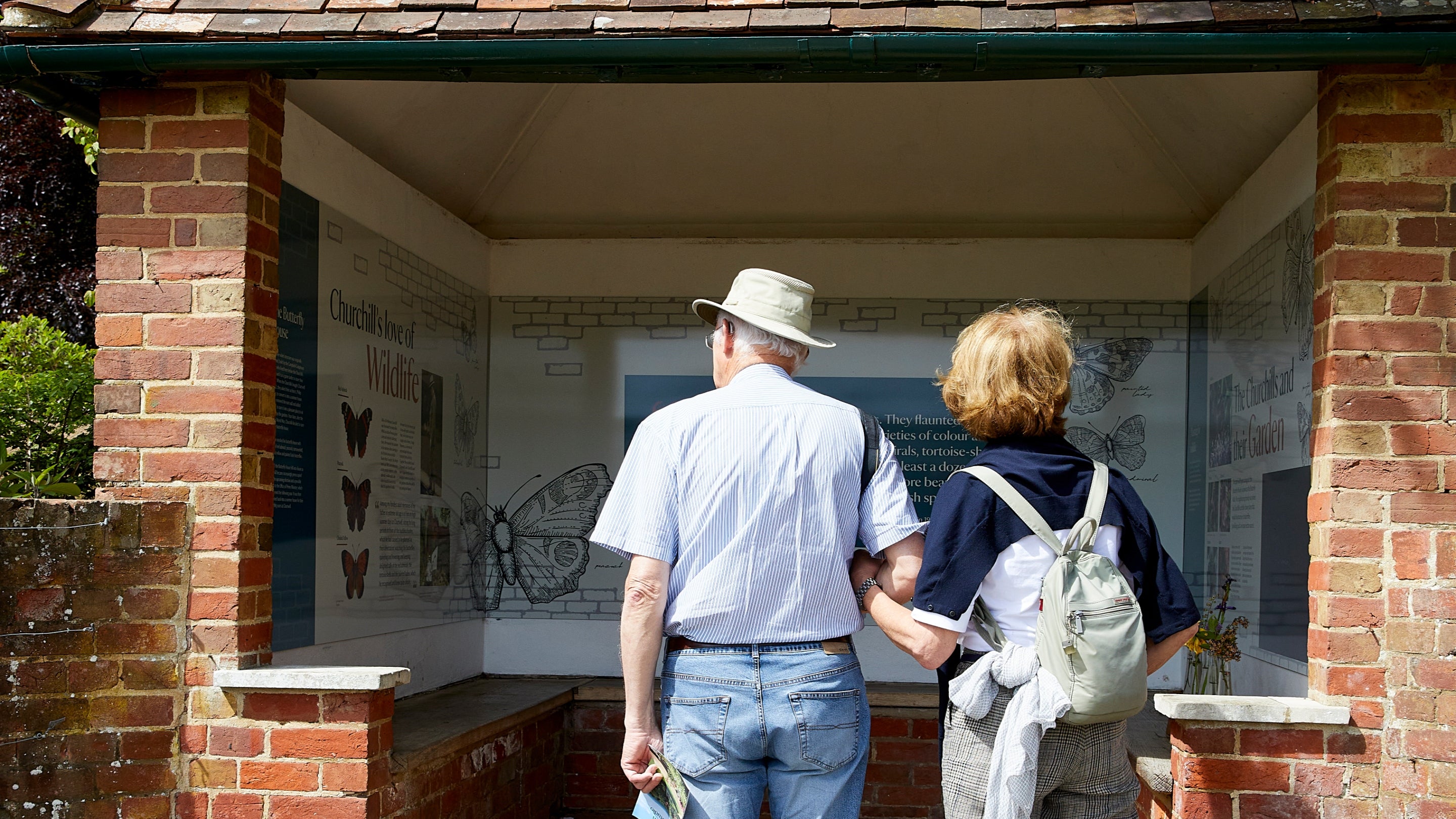 Two visitors reading the interpretation in the Butterfly House at Chartwell, Kent