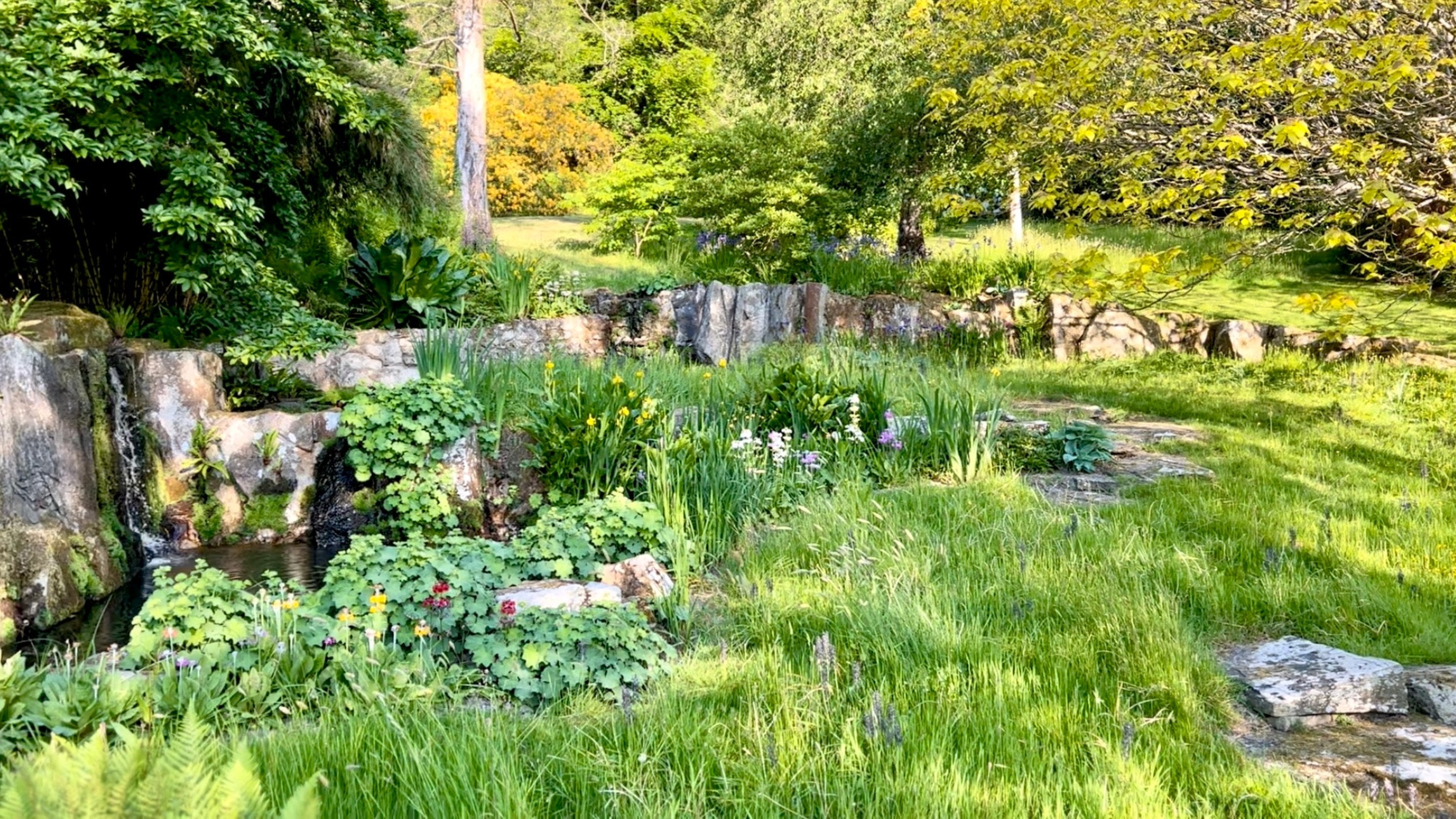 Water falls down the stones in the Gavin Jones Cascade in the garden at Chartwell, Kent