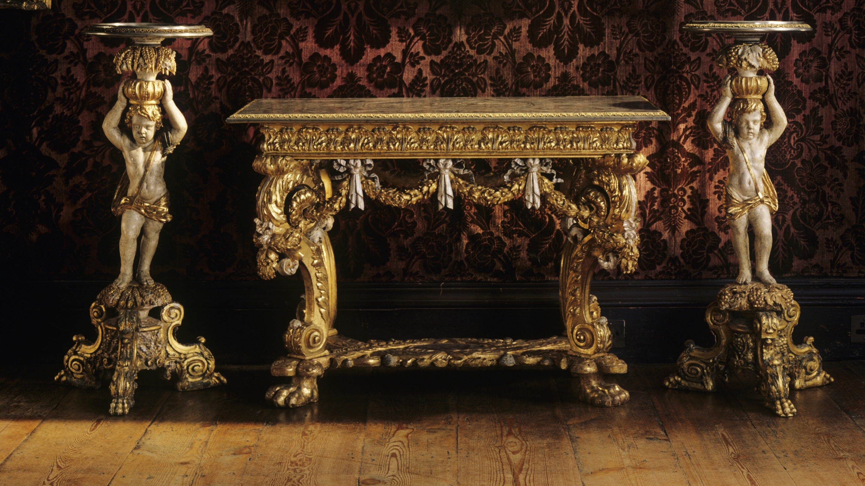 Close-up of carved and gilt table and candlesticks at Knole, possibly given by Louis XIV to the 6th Earl of Dorset in 1670. Gilded by Dupre, the tops are inlaid with pewter and brass