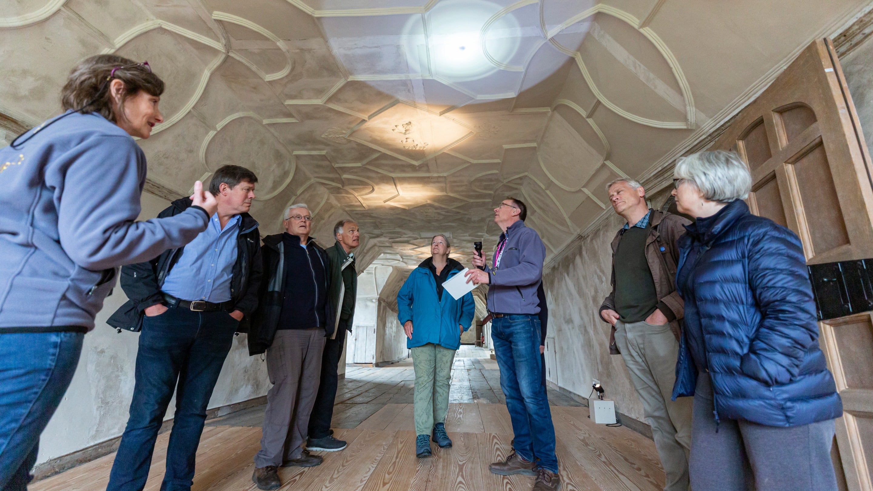 National Trust staff with a tour group in the Retainer's Gallery (attics) at Knole, Kent