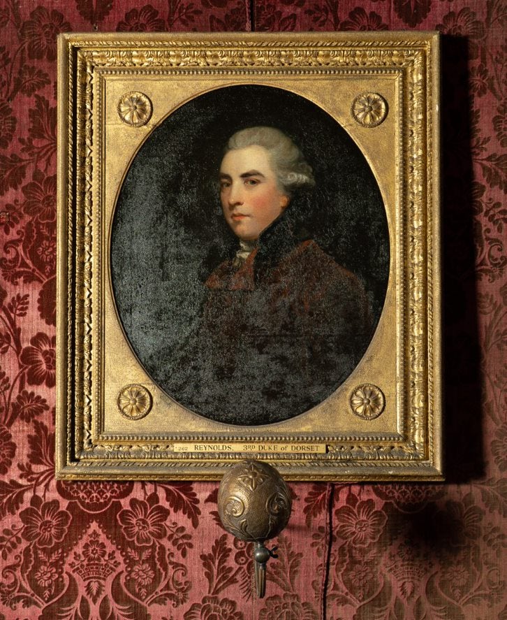 Painted portrait of a man in a gold coloured frame