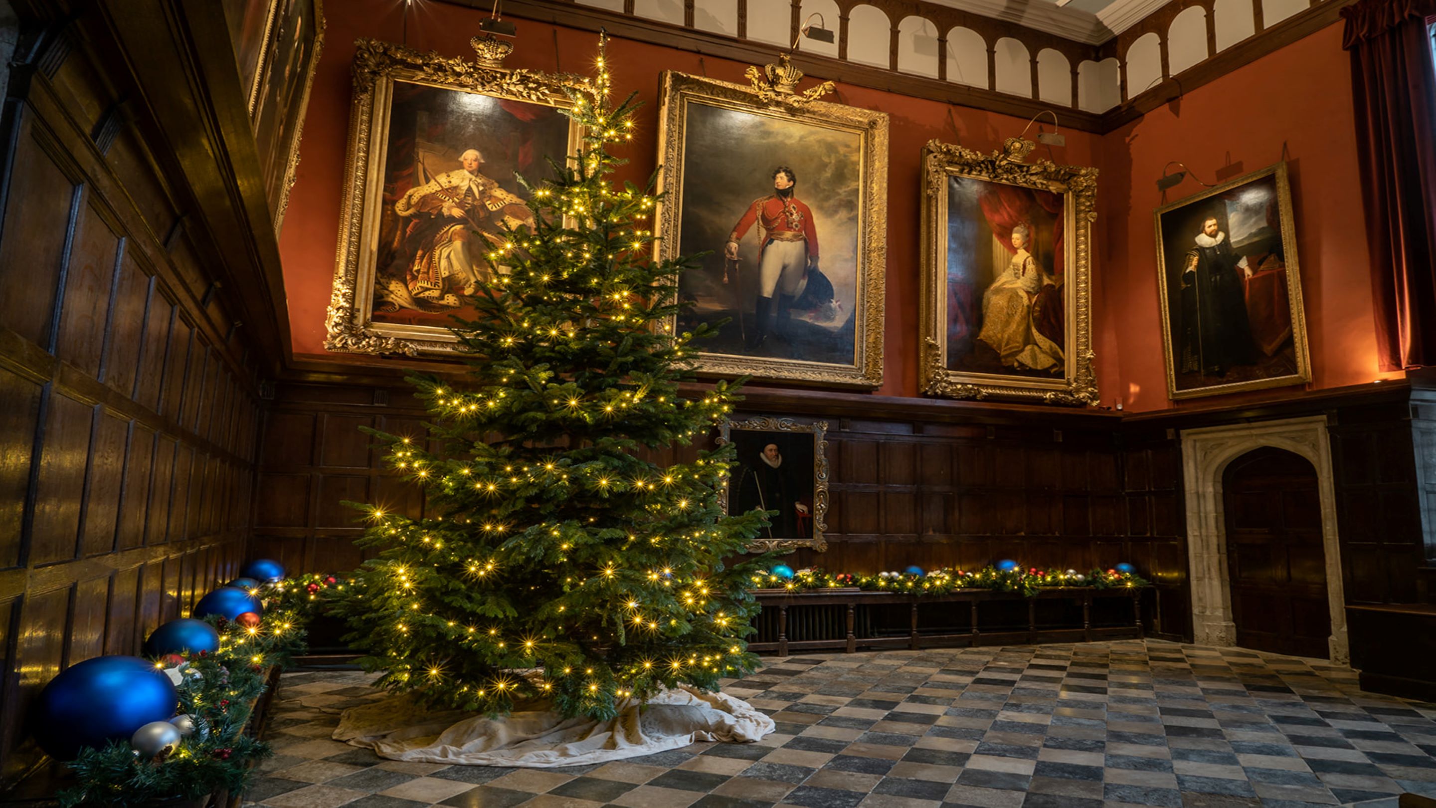 A Christmas tree and decorations in The Great Hall at Knole