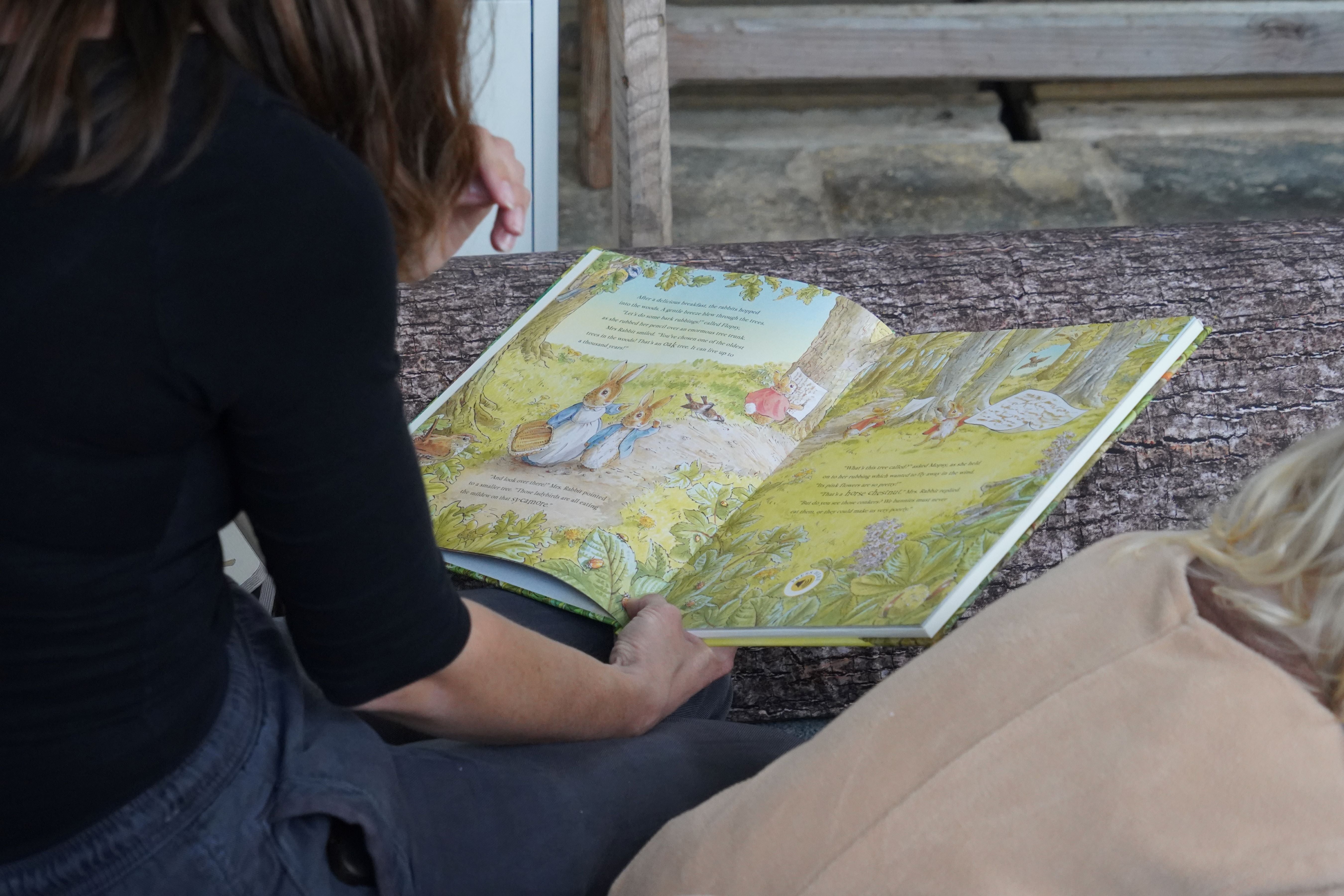 A person holding a book with colourful pages