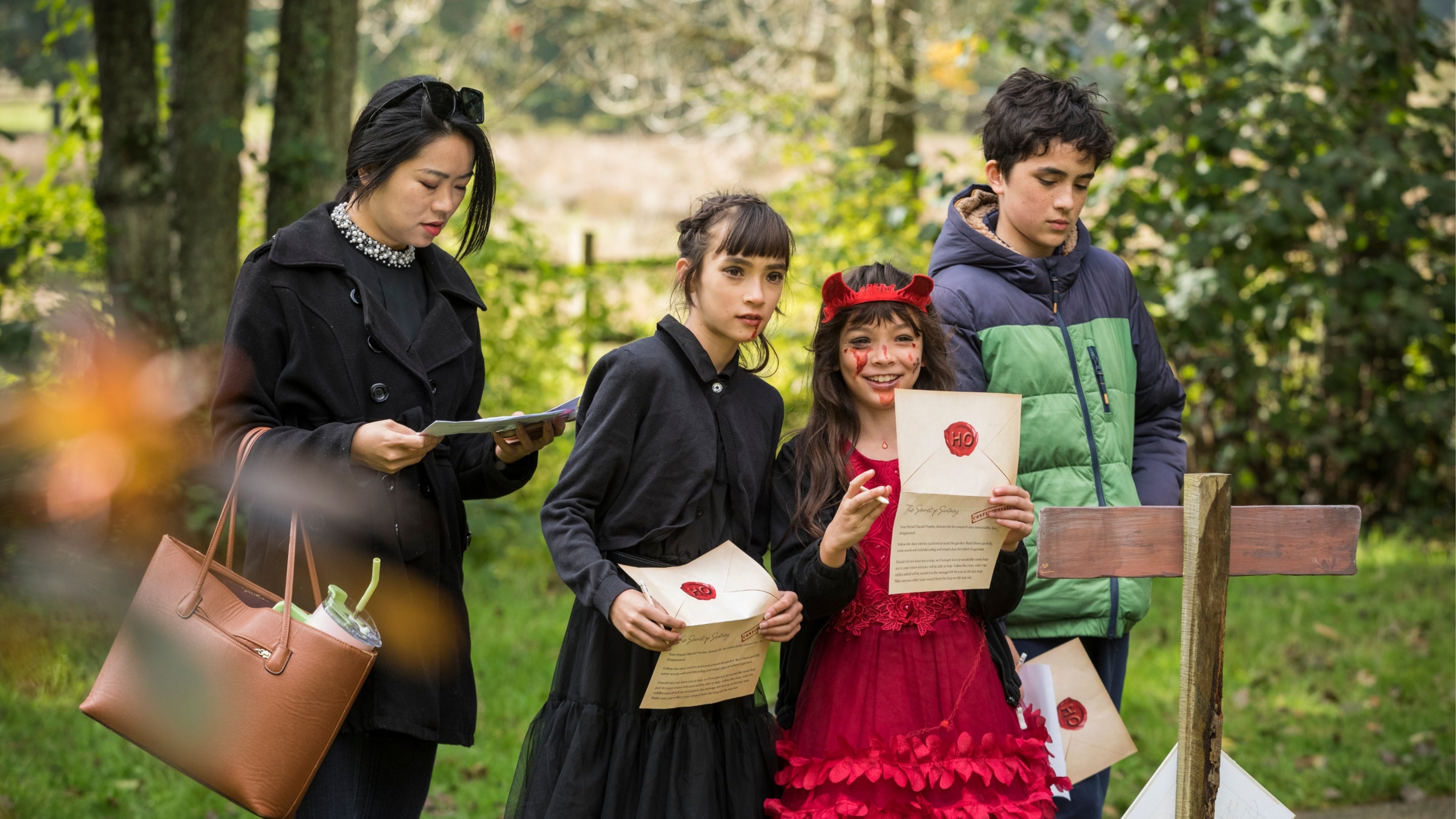 Children solving clues and cracking codes for Halloween at Scotney Castle, Kent