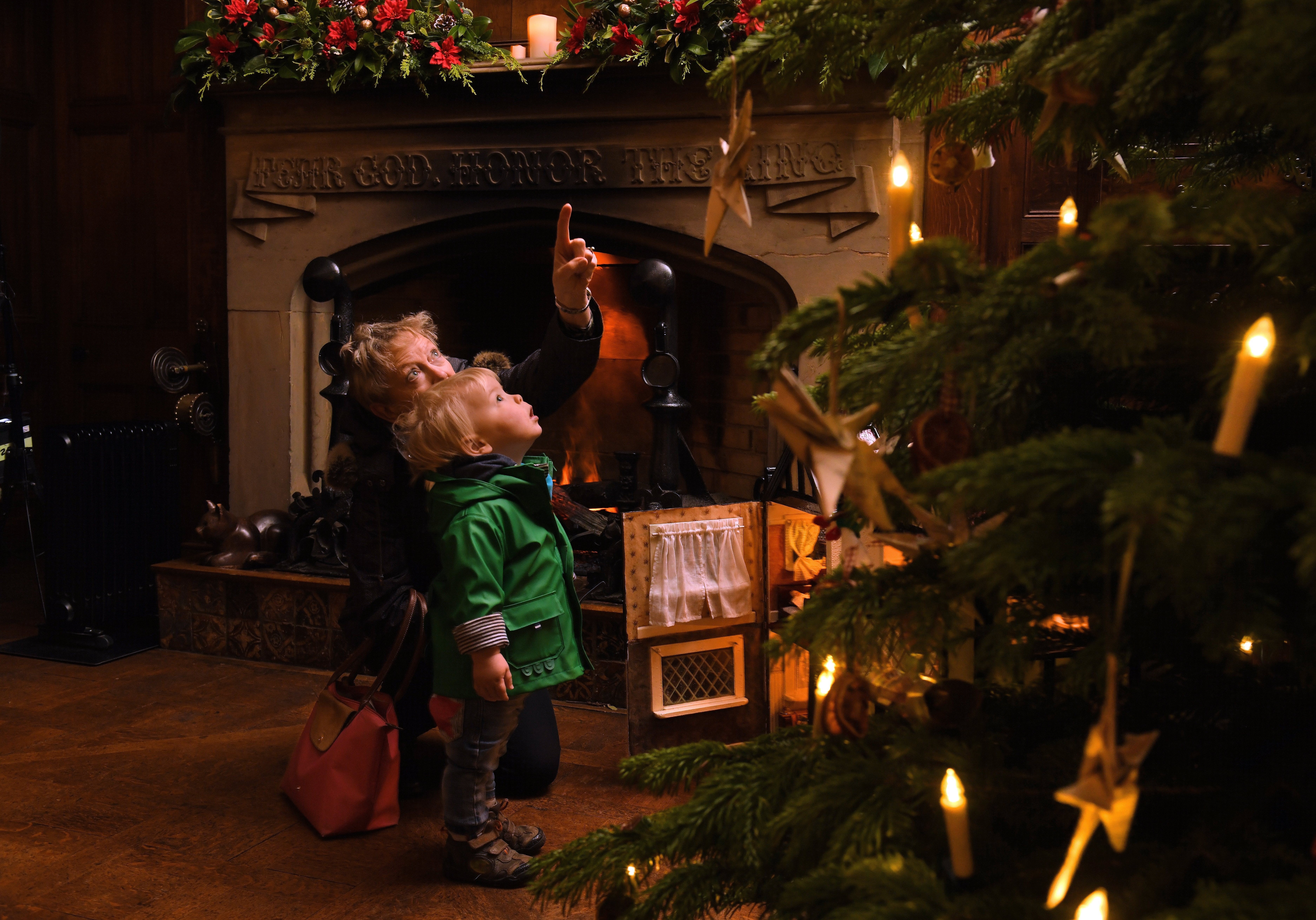 Little boy and grandmother looking at the Christmas tree at Scotney Castle