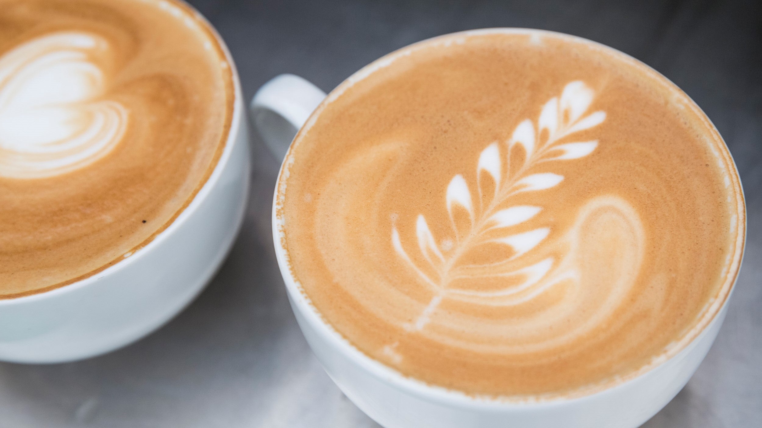 Two frothy coffees with decoration