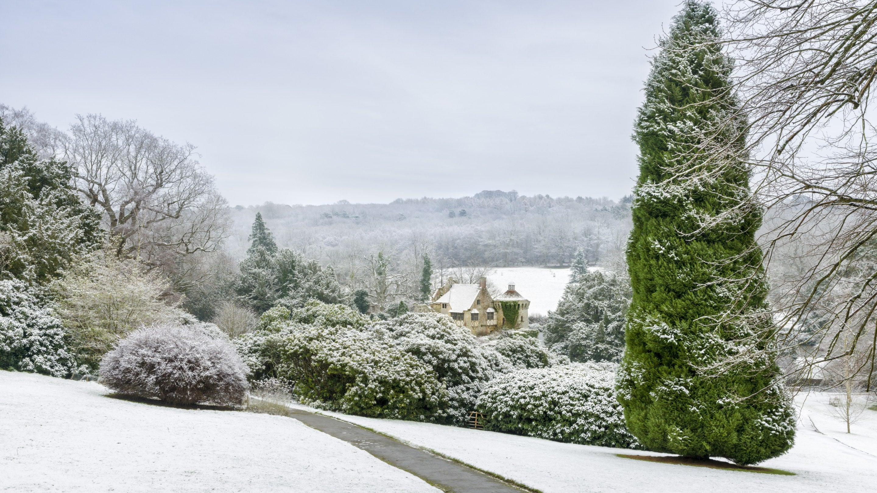 The garden and castle in January at Scotney Castle, Kent