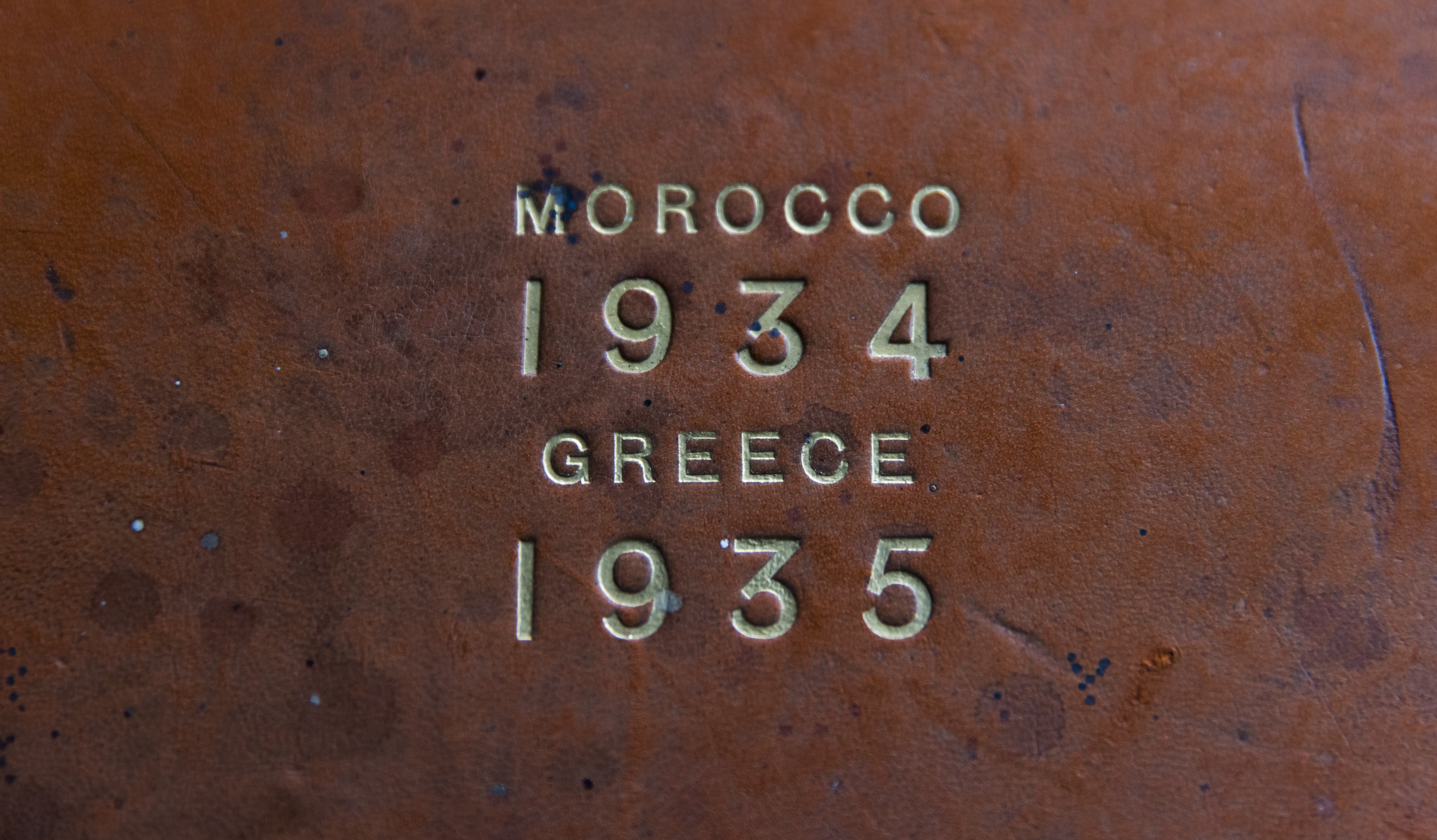 Gold embossed lettering on top of a worn album cover