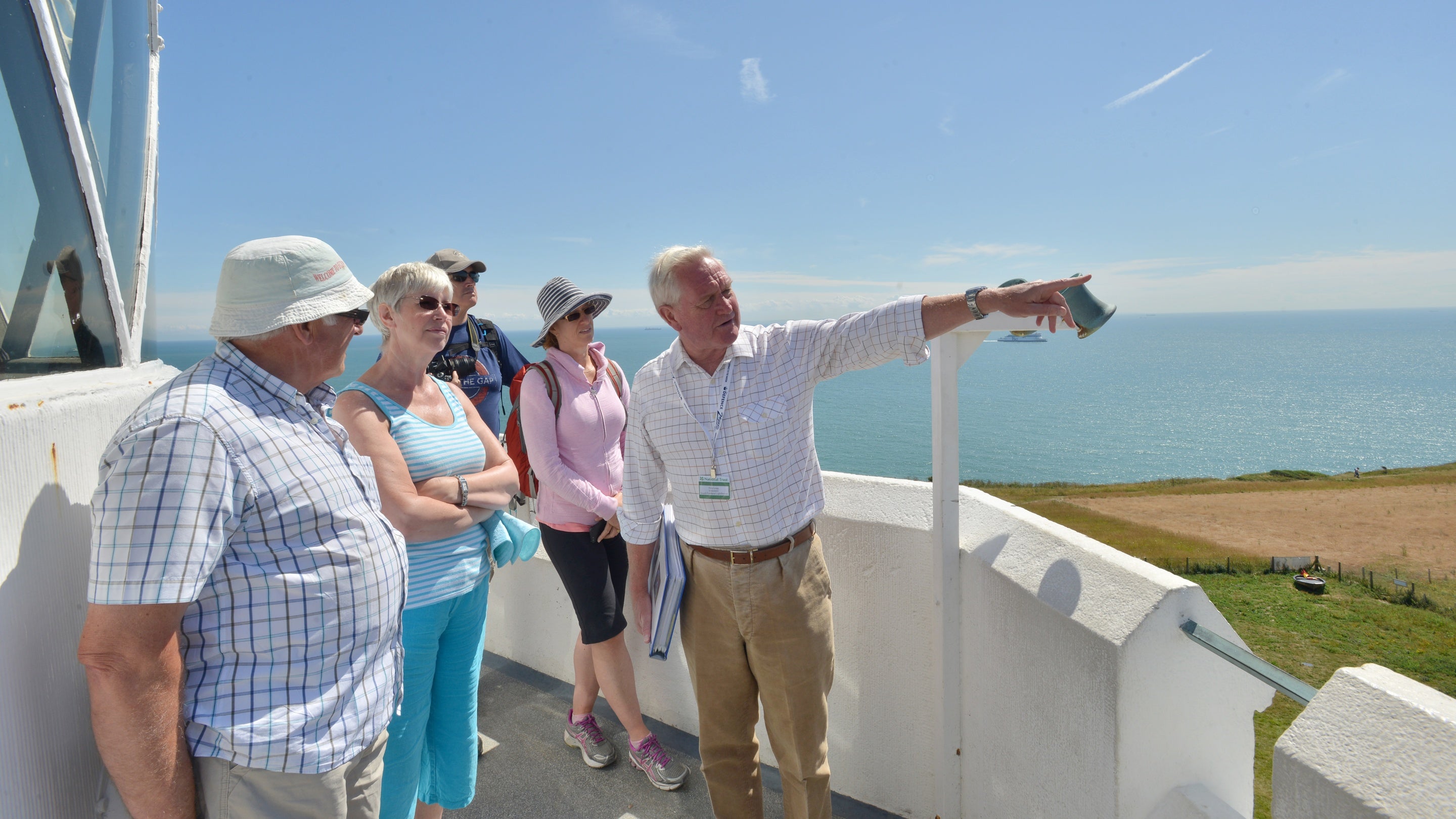 Image of a guided tour of South Foreland Lighthouse on the balcony of the lighthouse with their guide on a sunny day