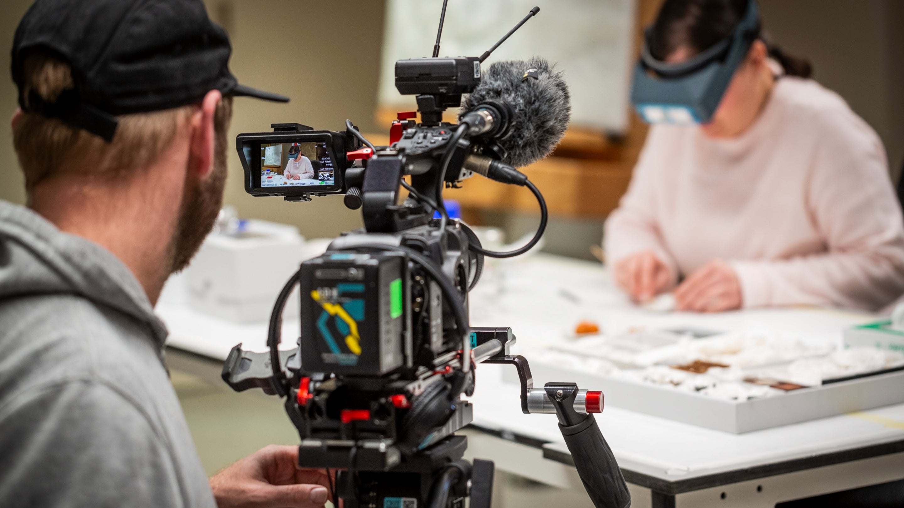 An image of a TV camera operator filming a person while they carry out conservation work during the production of BBC 2’s Hidden Treasures of the National Trust Series 3