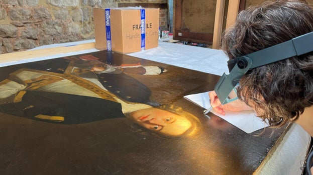 A conservation scientist taking a paint sample from the Sir Joshua Reynolds portrait of Lieutenant, later Captain, Paul Henry Ourry, MP (1719-1783) with a young attendant known as 'Jersey' from Saltram House.