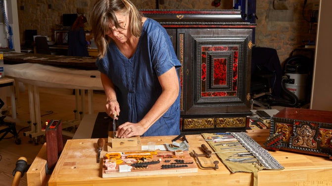 A conservator working on a seventeenth century Flemish art cabinet at The Royal Oak Foundation Conservation Studio