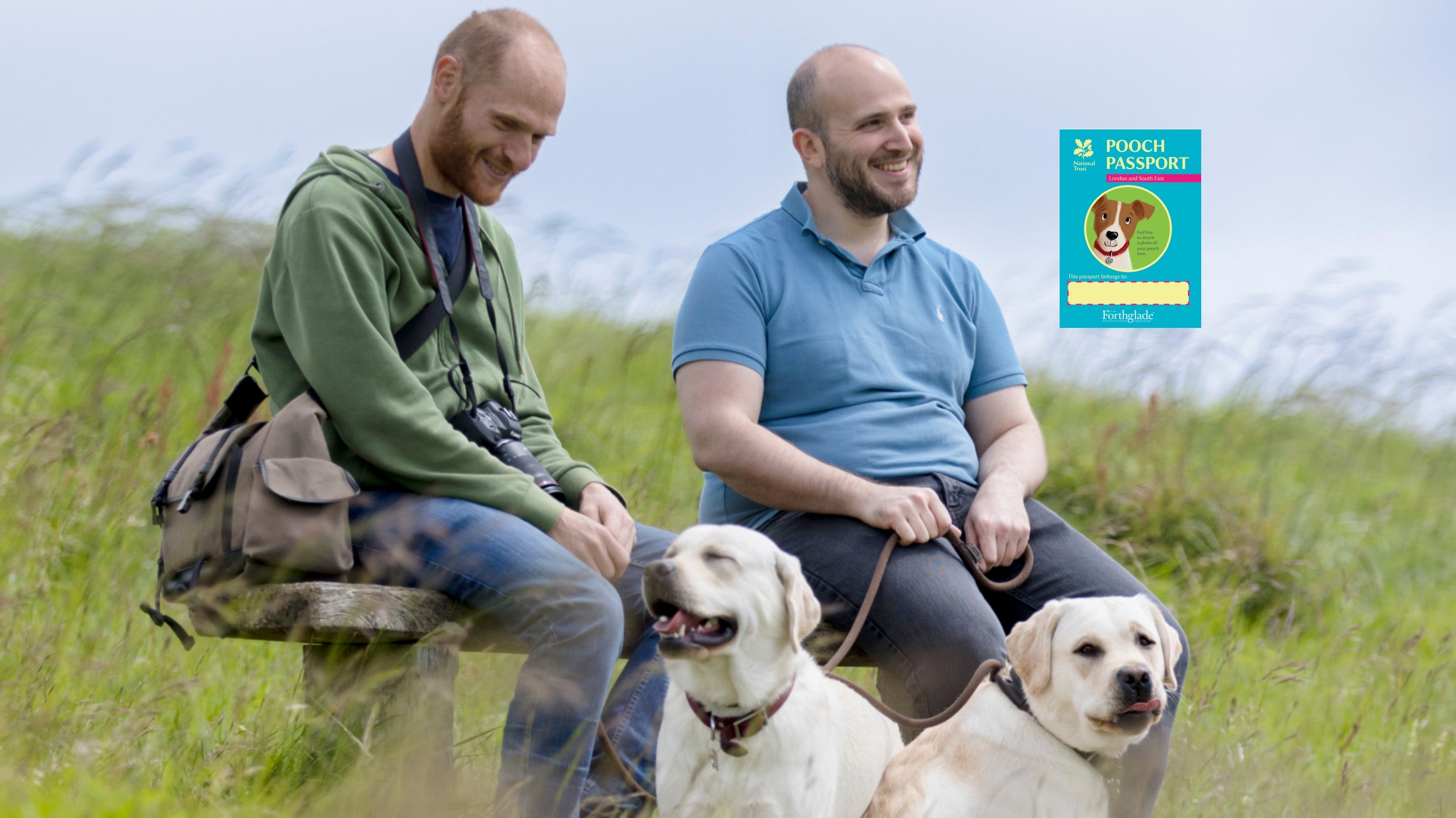 Image of two men and their dogs taking a well-earned break from their walk at the White Cliffs of Dover
