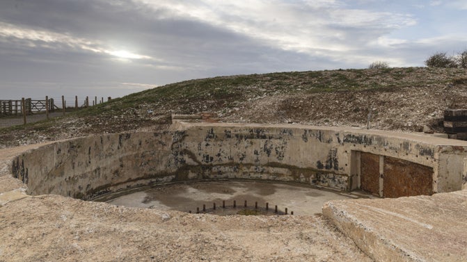Image of a disused 6-inch gun emplacement showing the mounting bolts on a cloudy day