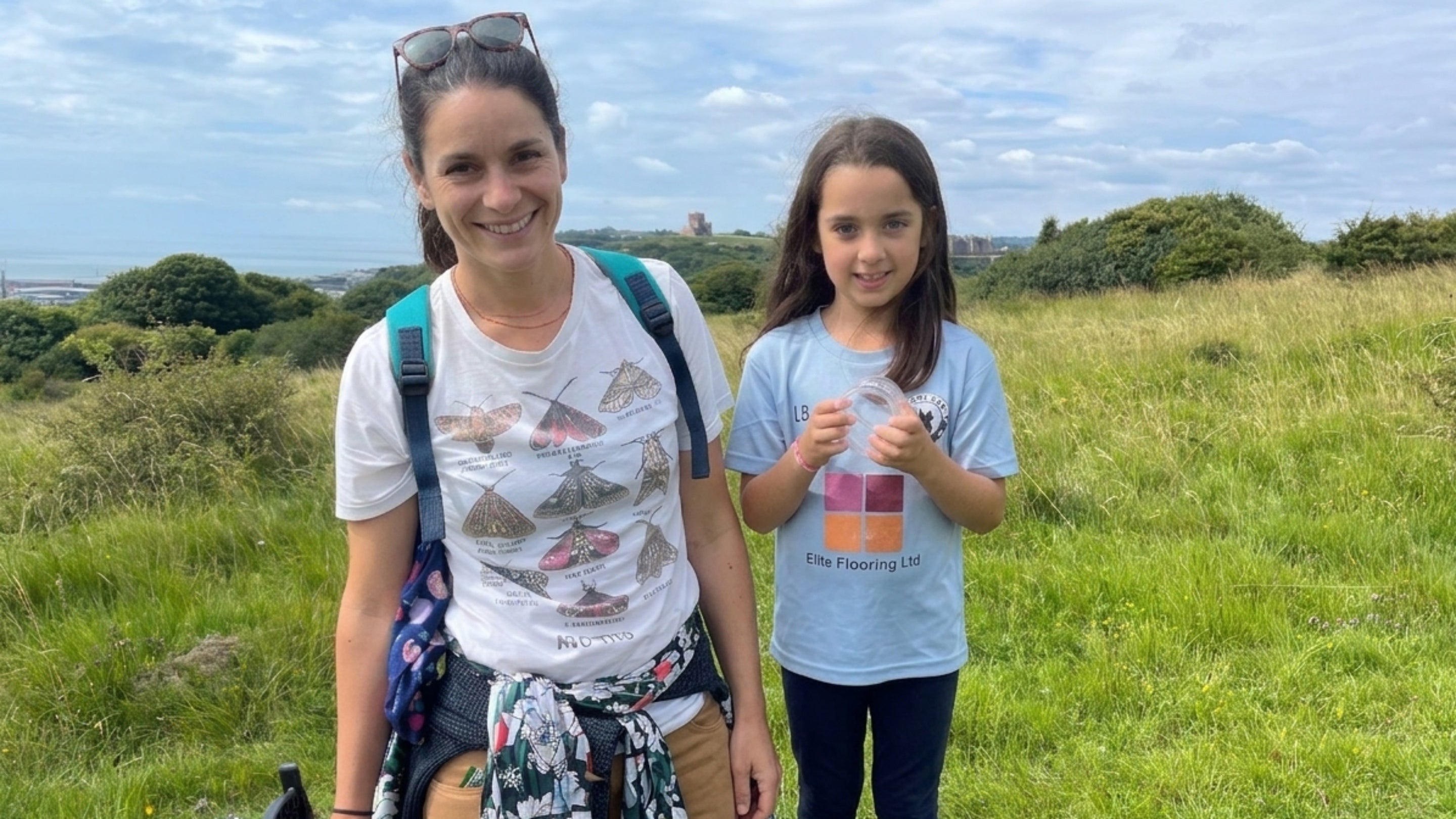 Image of a mother and child hunting for bugs at the White Cliffs of Dover on a sunny day
