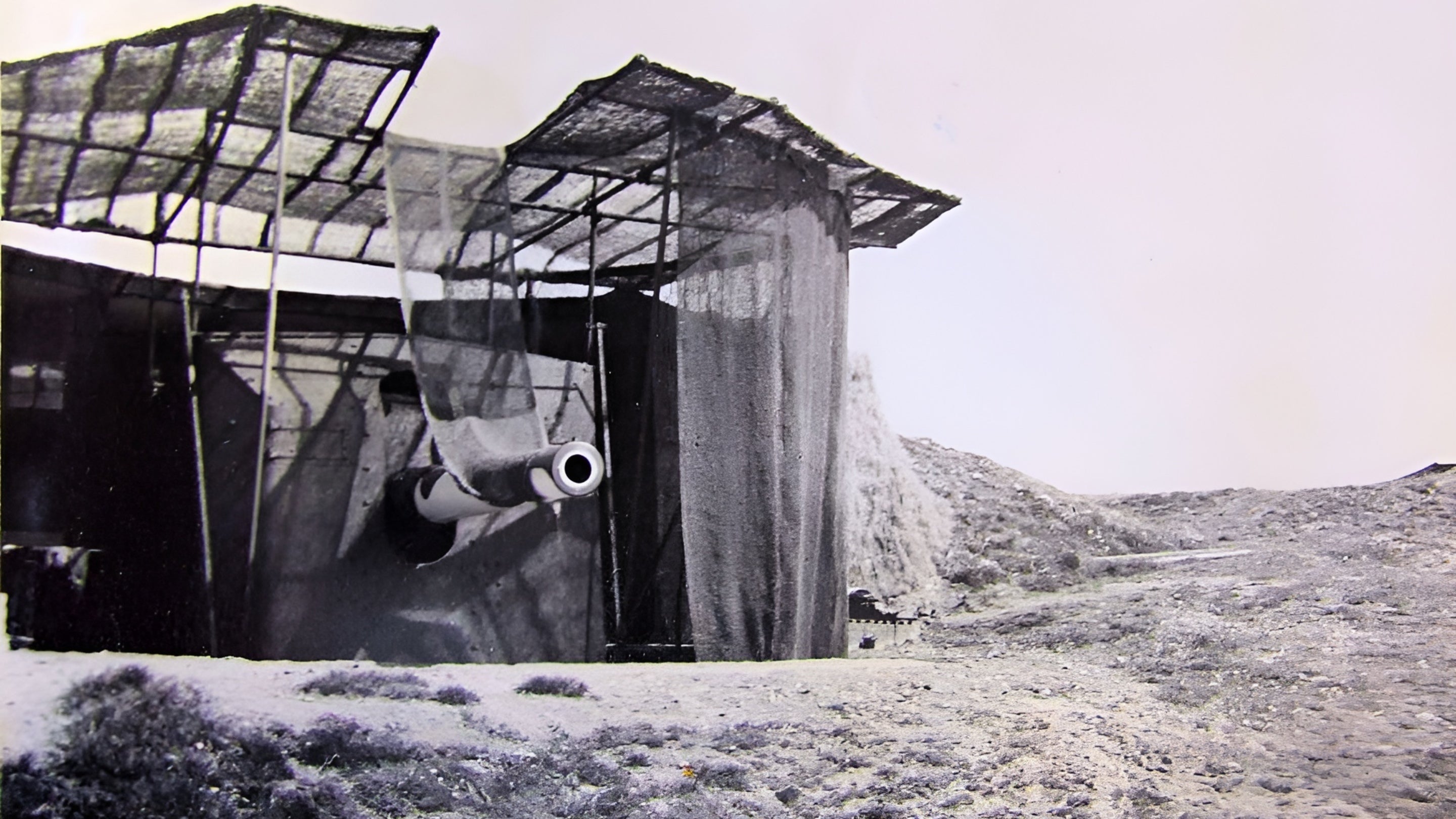 Black and white image of one of the 6-inch Fan Bay guns with the barrel lowered into the loading position