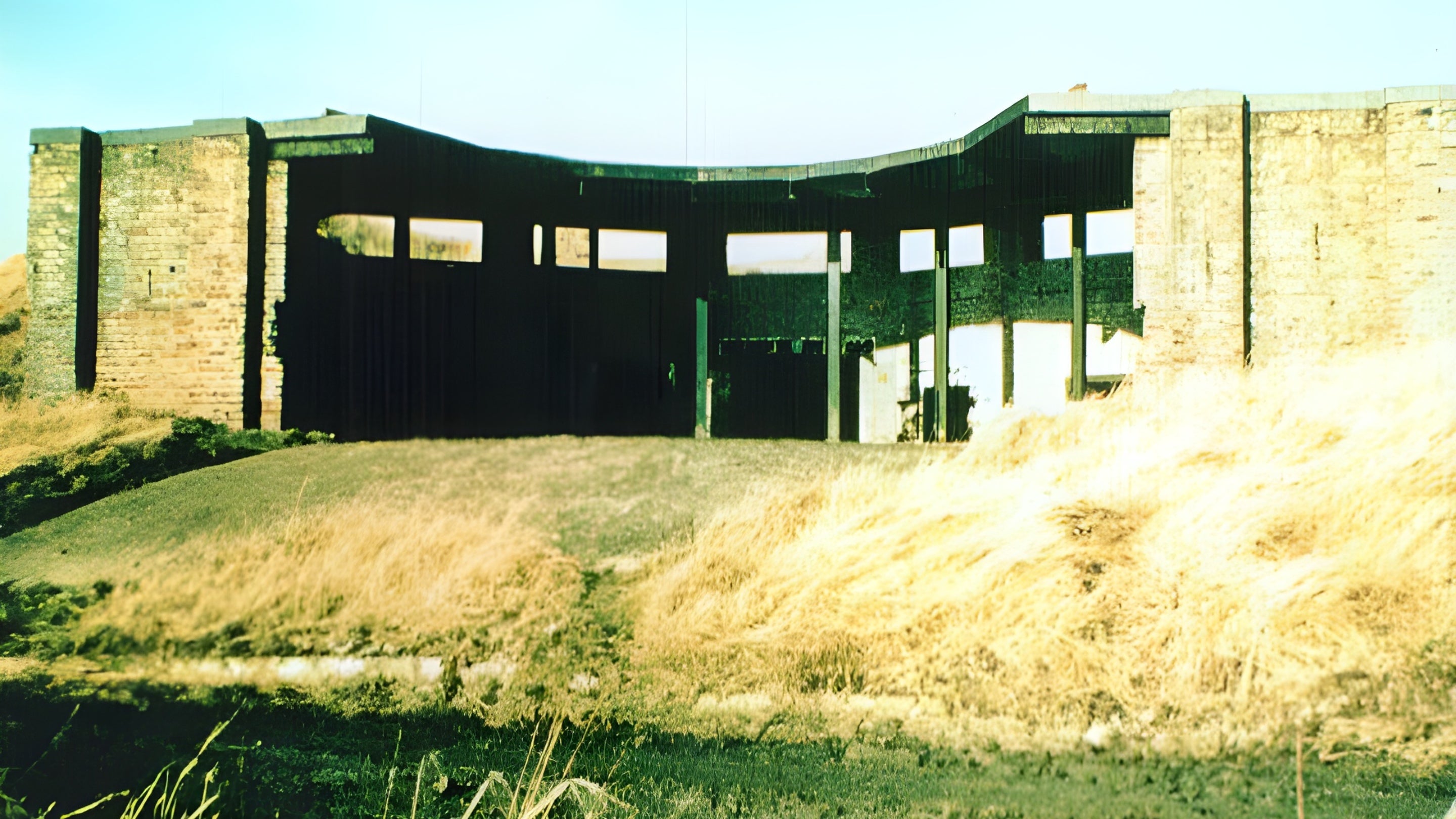 Image of a brick gun emplacement building without the gun taken in the early 1960s before demolition