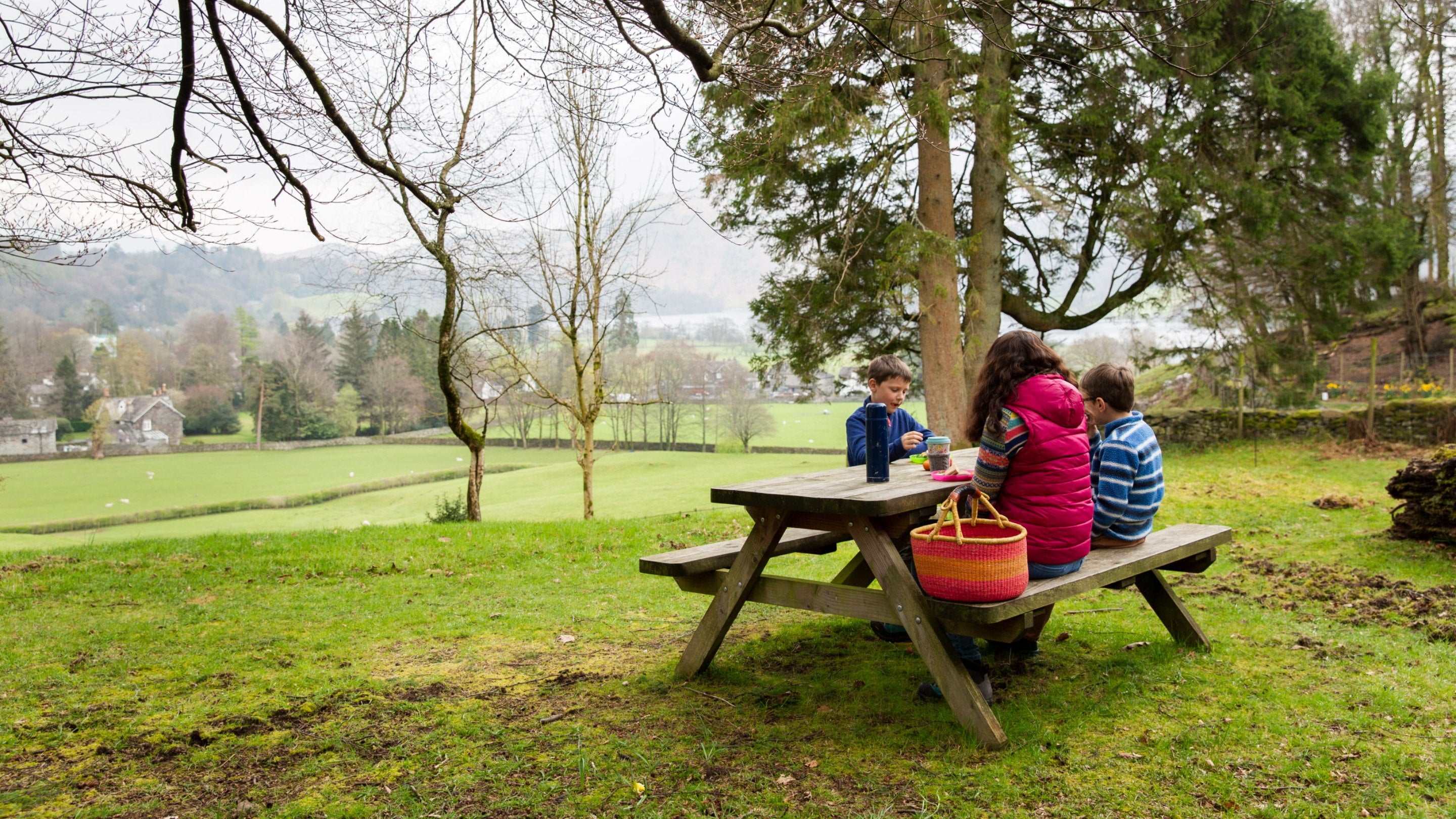 A family enjoy a picnic at Allan Bank and Grasmere, Cumbria