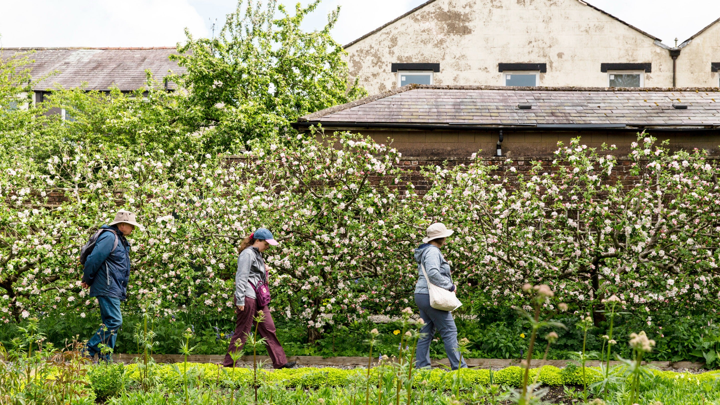 Visitors exploring the garden at Wordsworth House and Garden, Cumbria