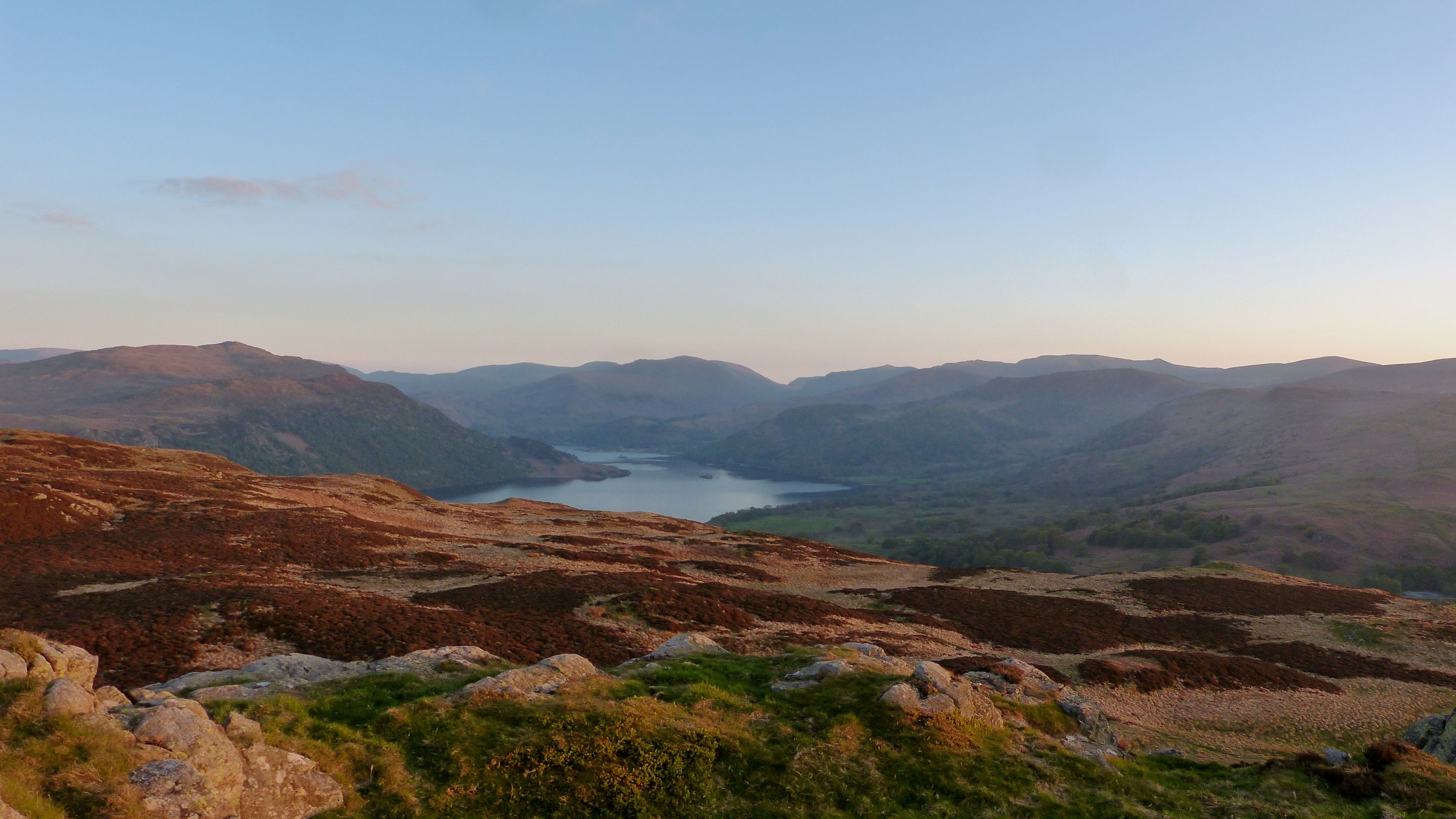 View from Gowbarrow summit overlooking Ullswater in summer in the evening sunshine