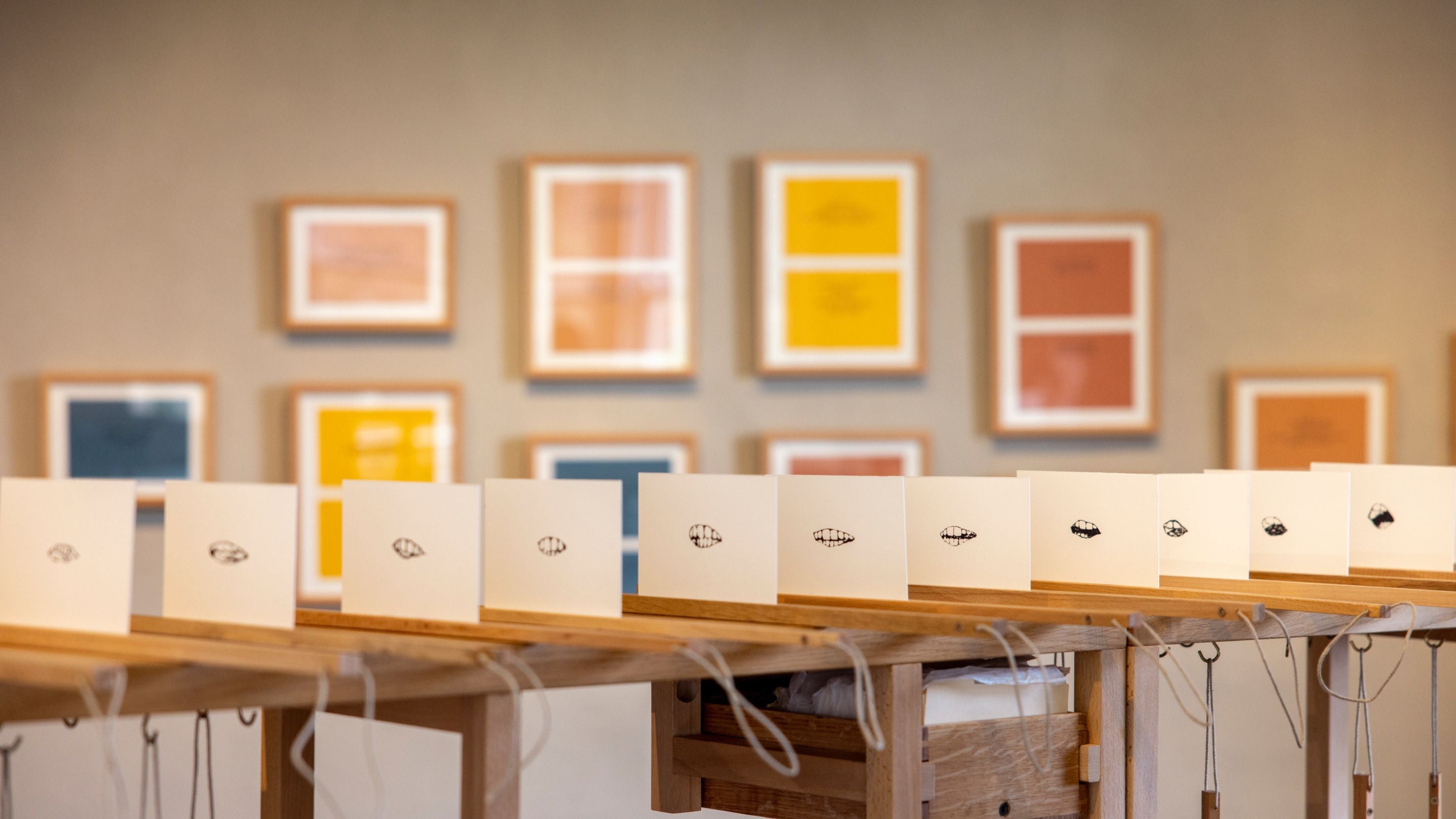 Art exhibition with framed color works and interactive black-and-white prints on display at Allan Bank, Grasmere.