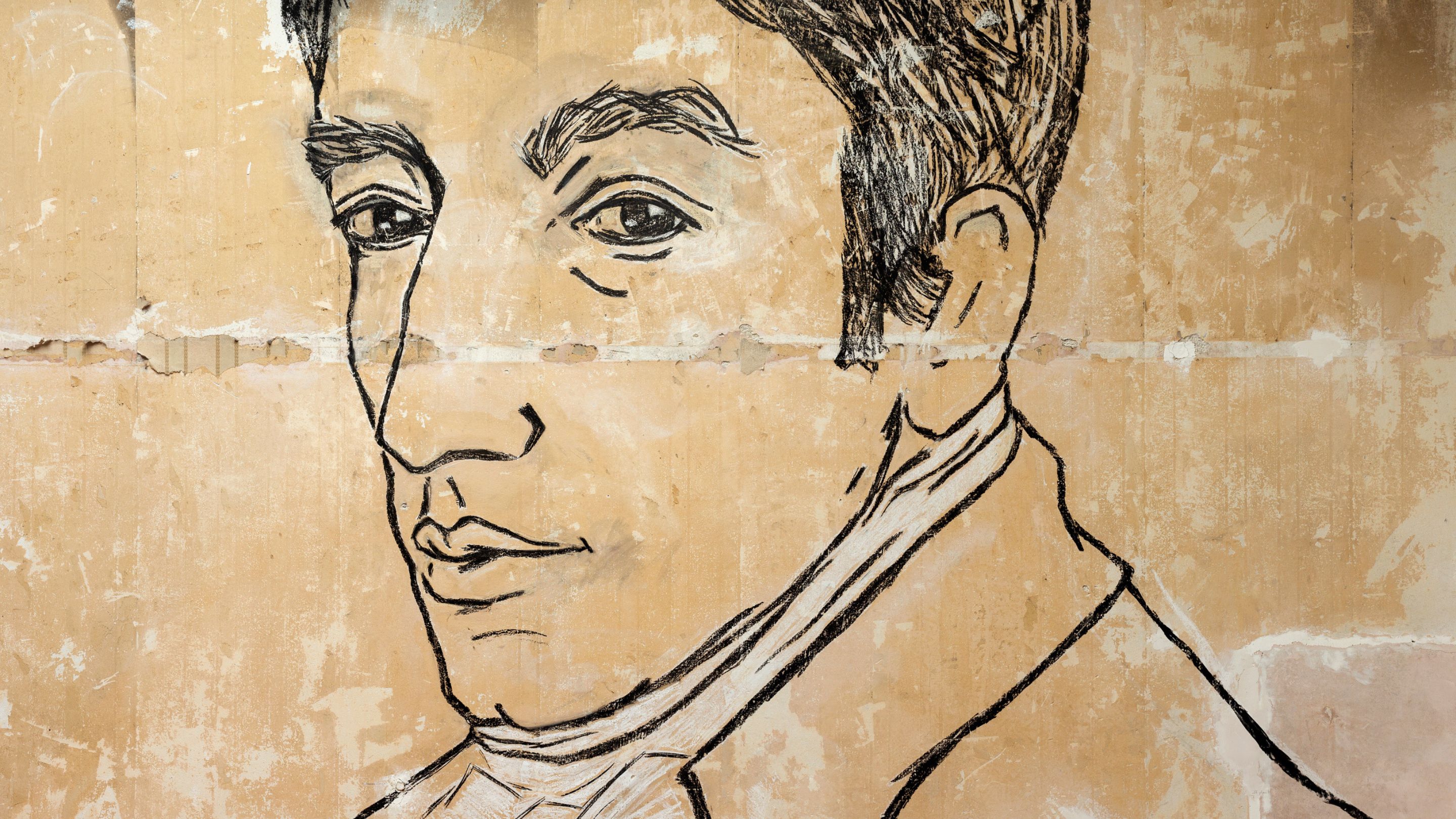 Large scale mural on a cream wall featuring an illustration of William Wordsworth's head in black charcoal ..