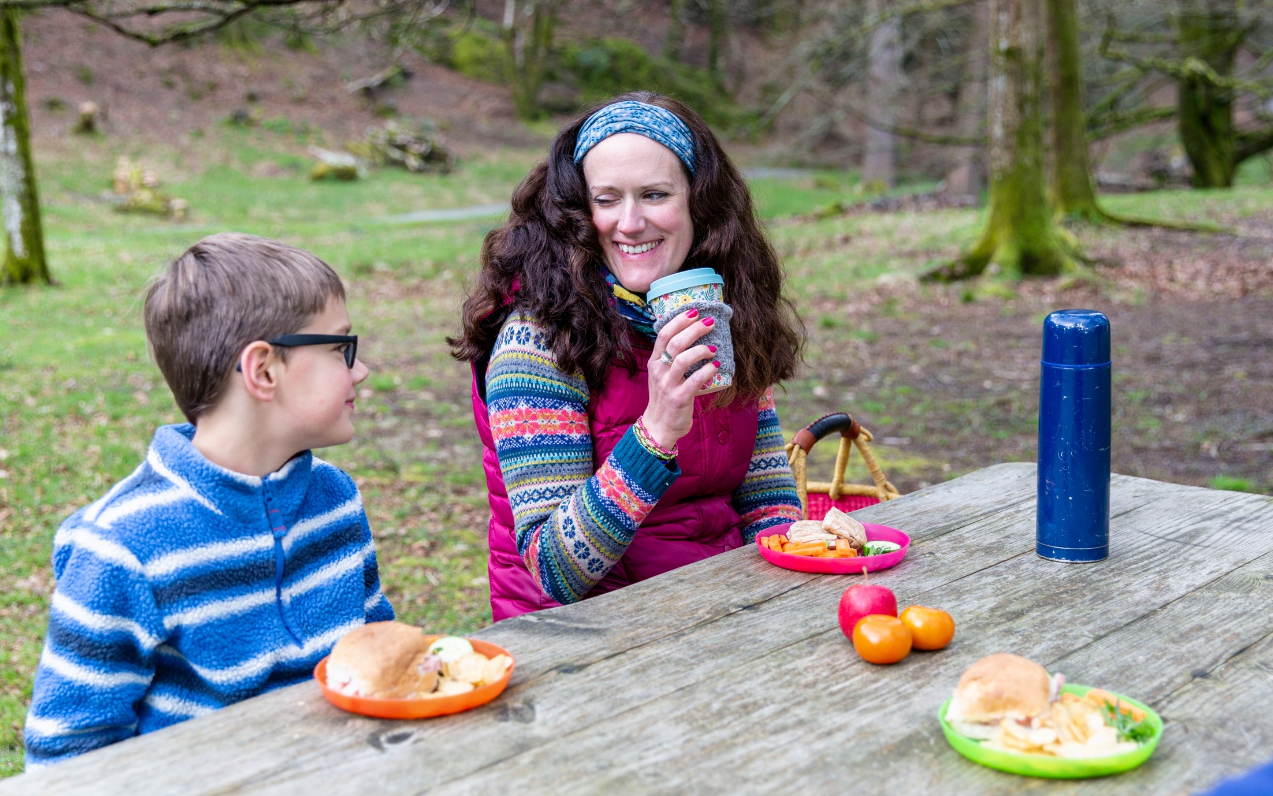 A family enjoying a picnic in the grounds at Allan Bank in Grasmere