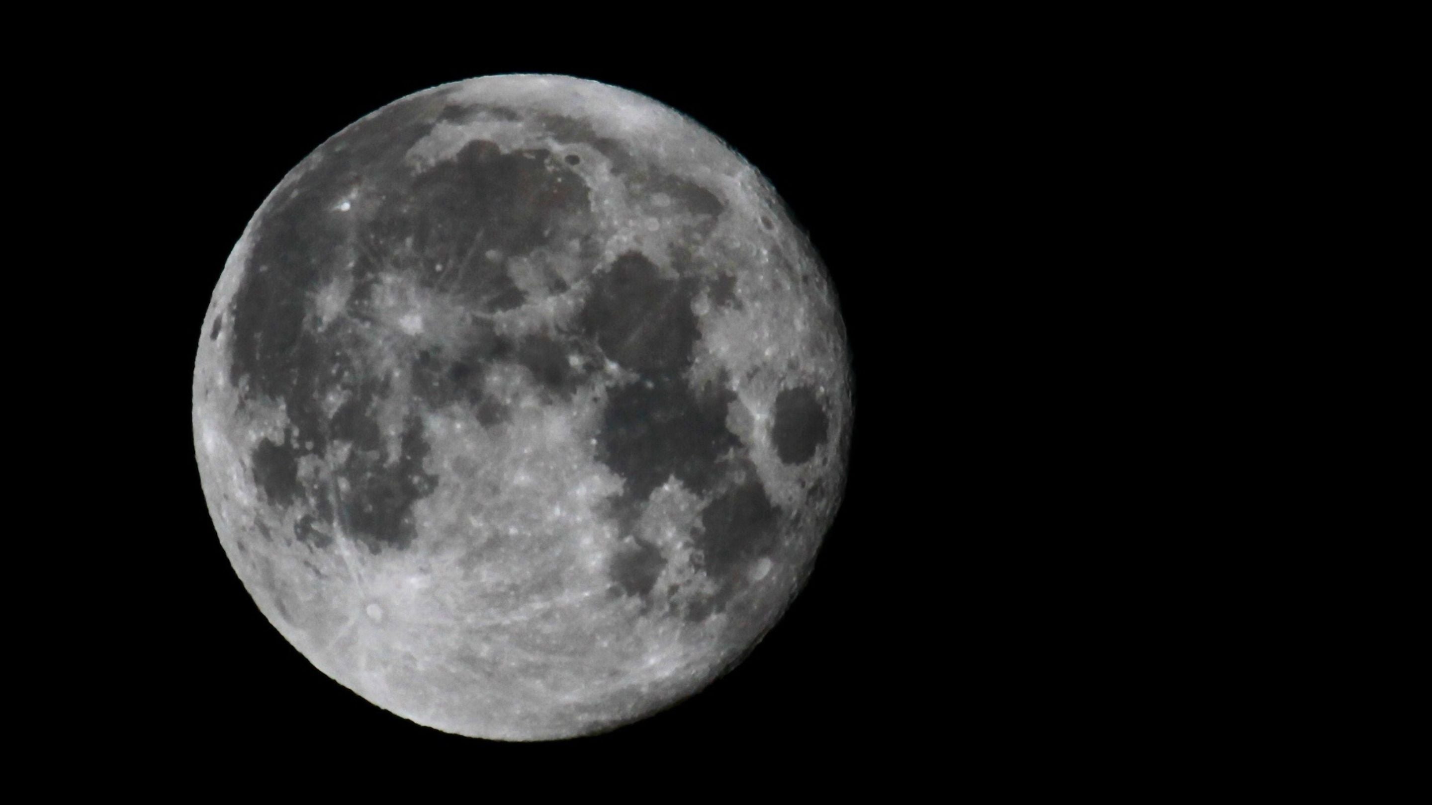Full moon against a dark black sky.