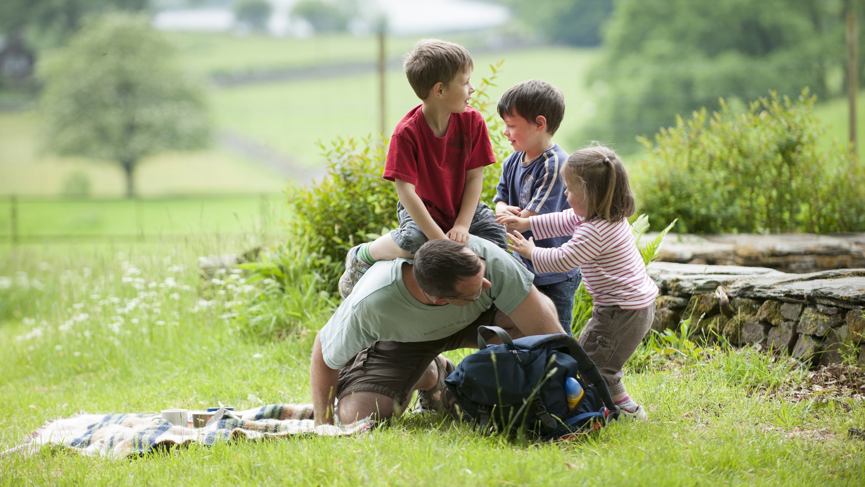 Family playing on the grass at Allan Bank, Grasmere, Cumbria