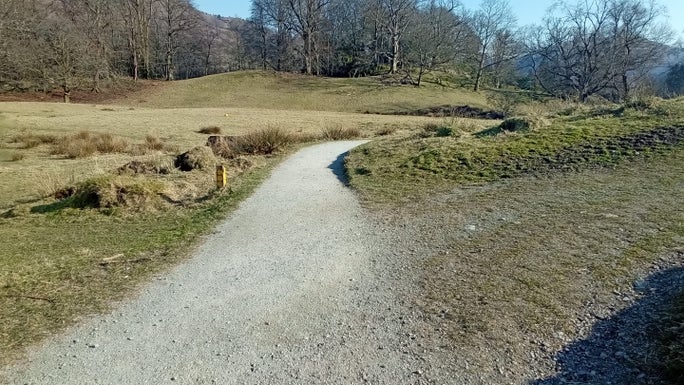 A gravel footpath bending around to the right with a footpath junction, Allan Bank and Grasmere, Cumbria